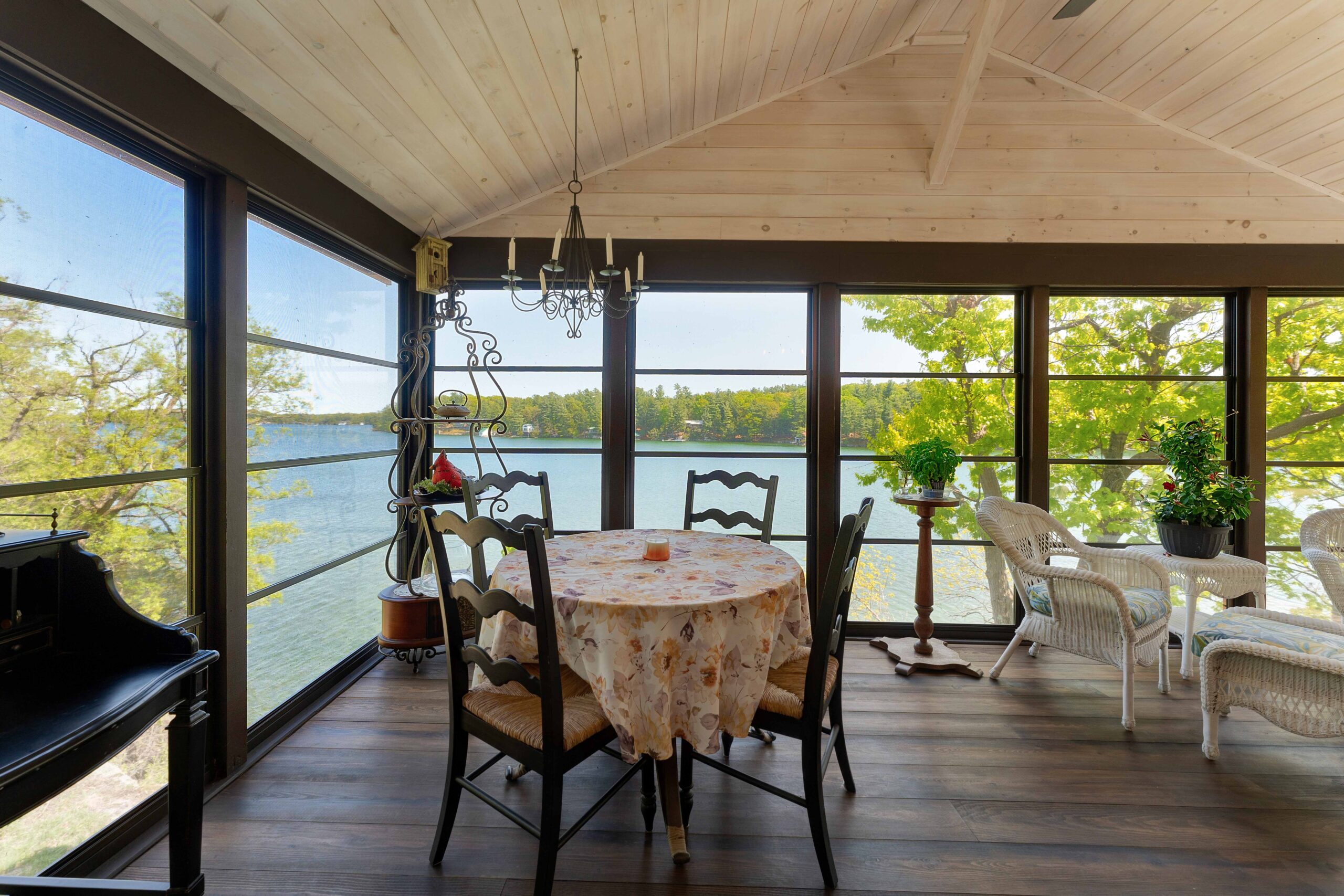 A small round table in the corner of a sunroom