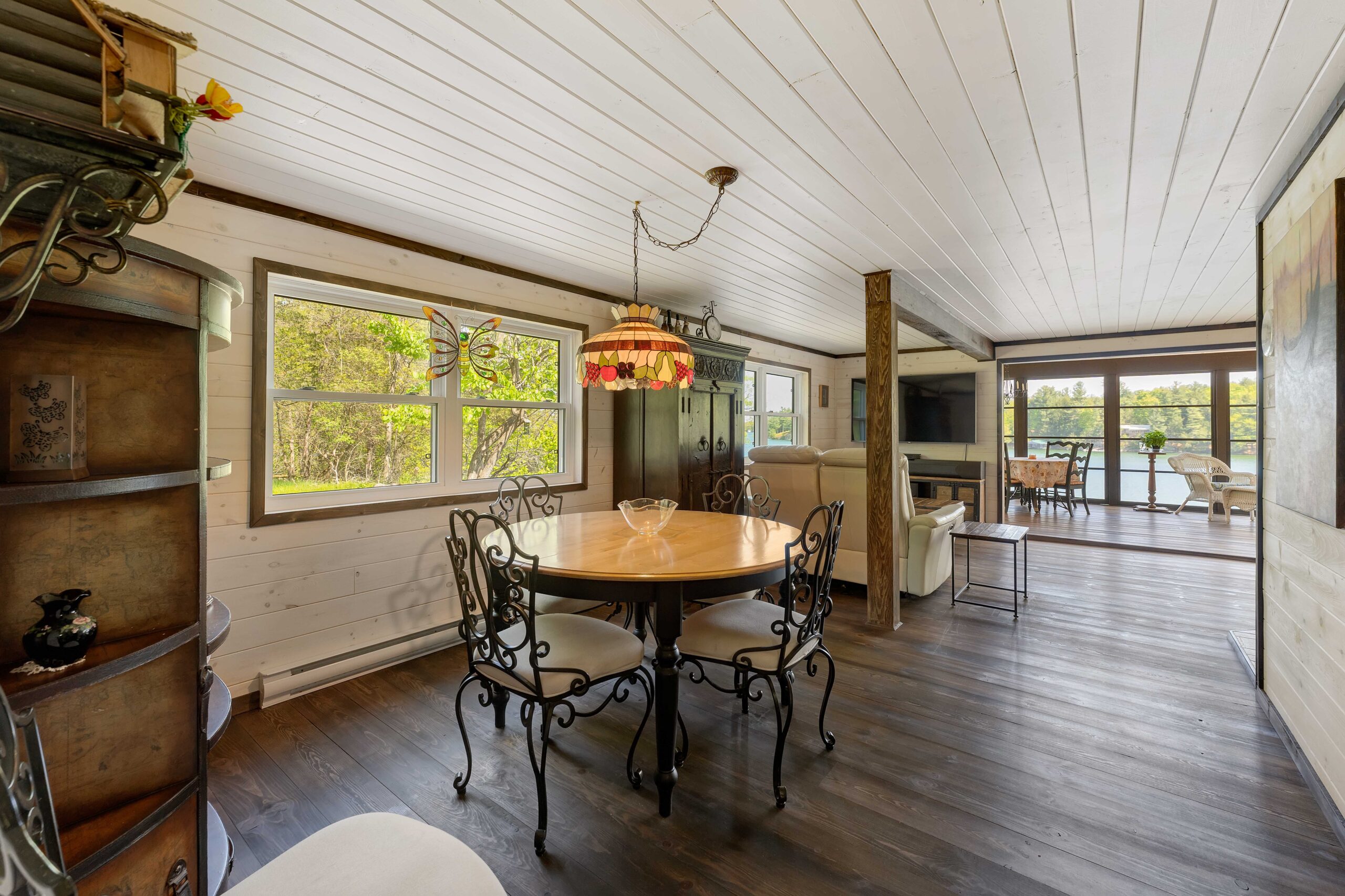 A small round dining table next to a window