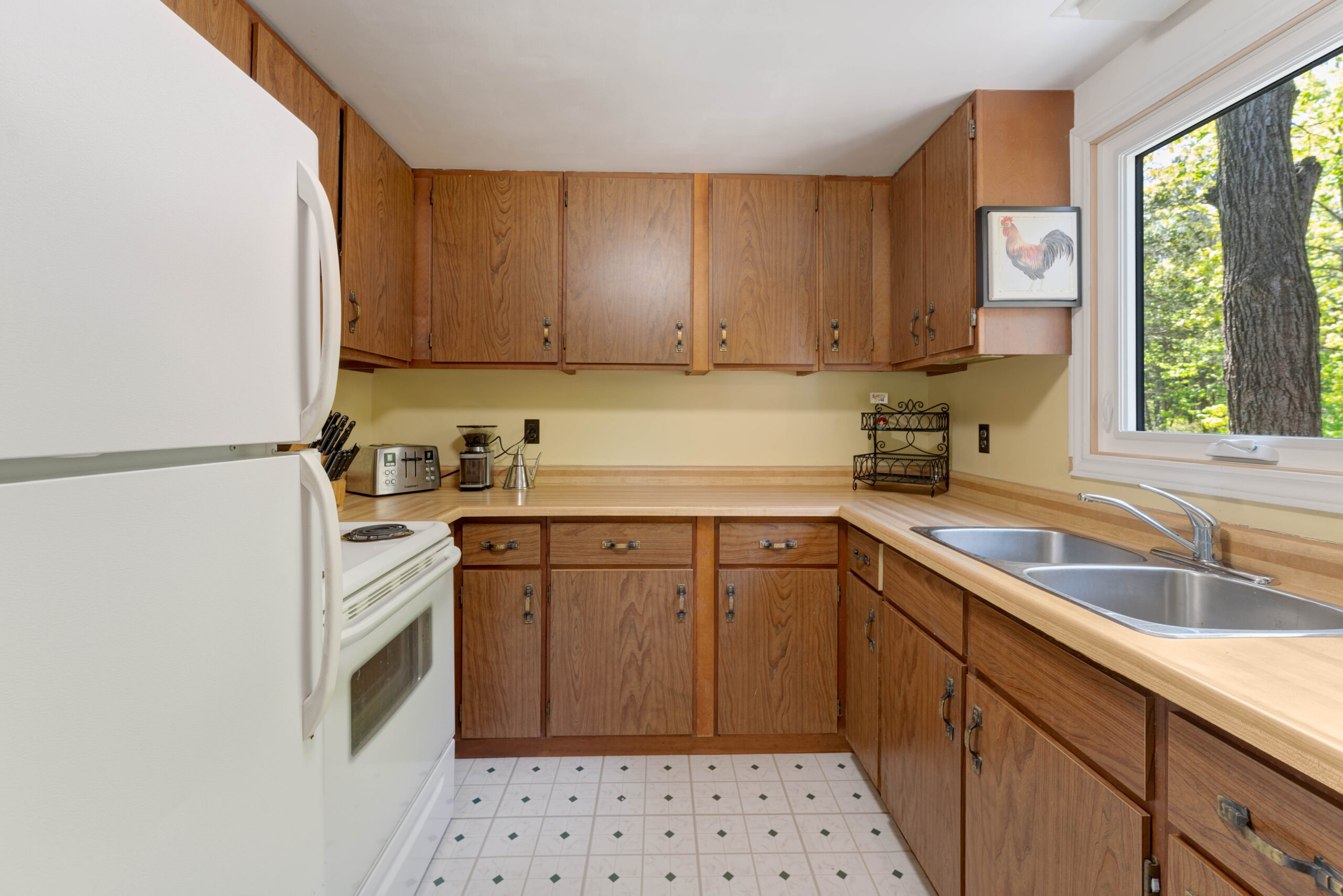 A brown wood kitchen with white appliances