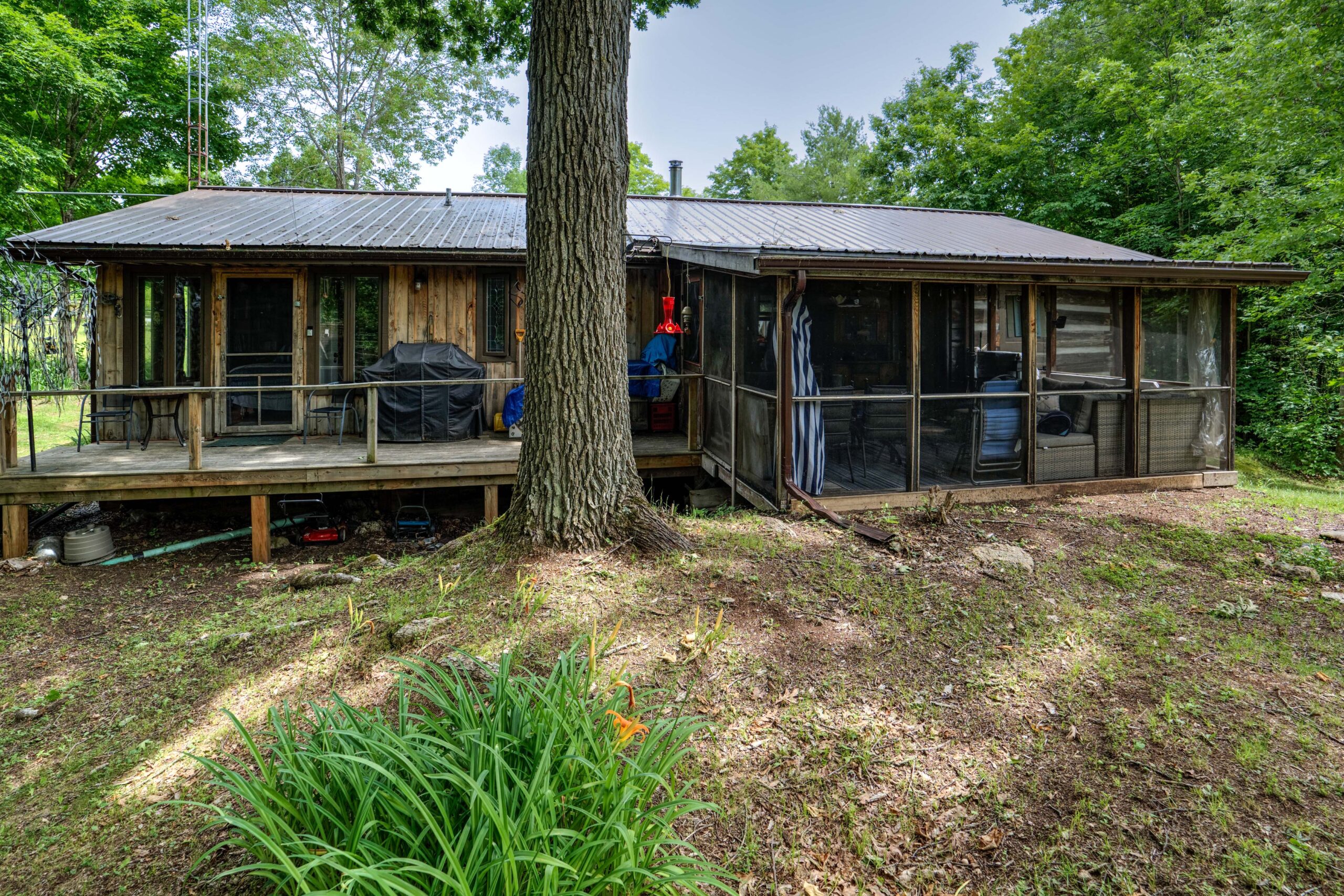 A screened-in back room on a bungalow house