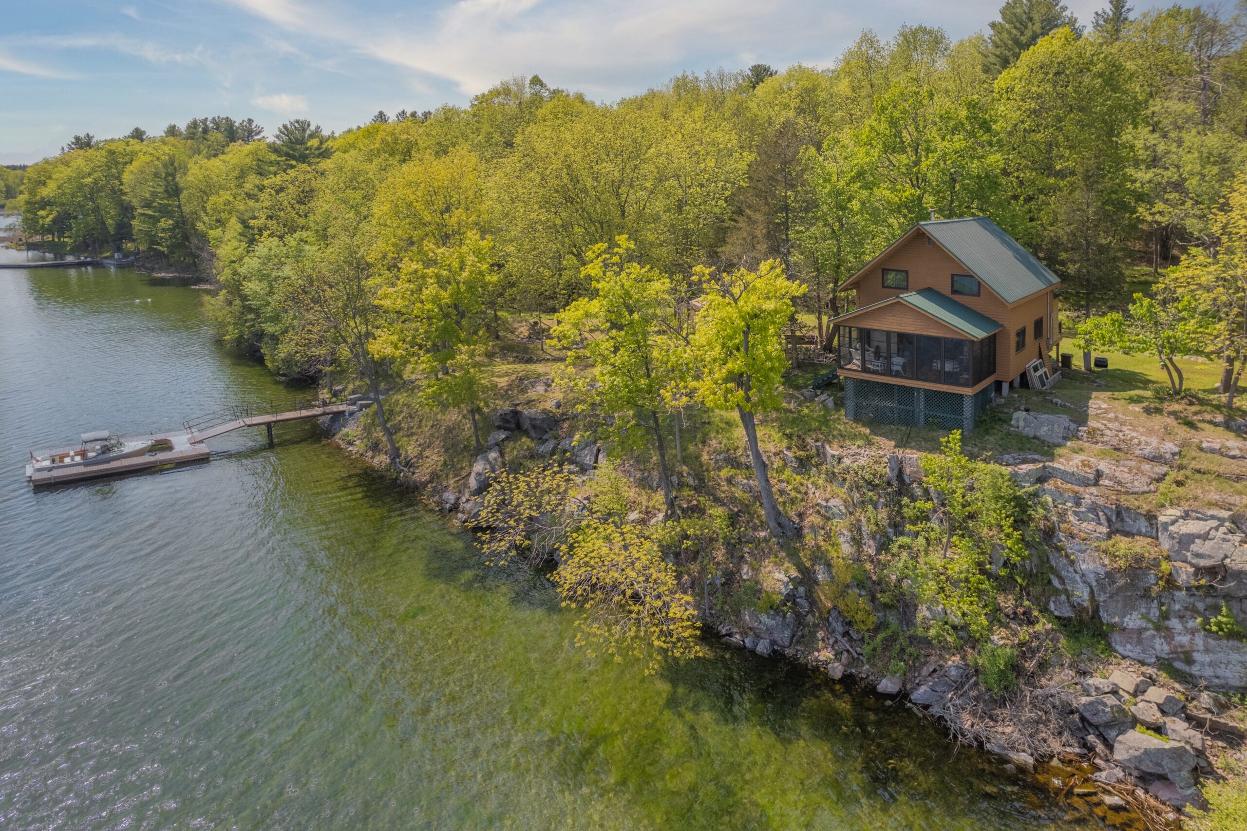 A small cottage sits high above the water