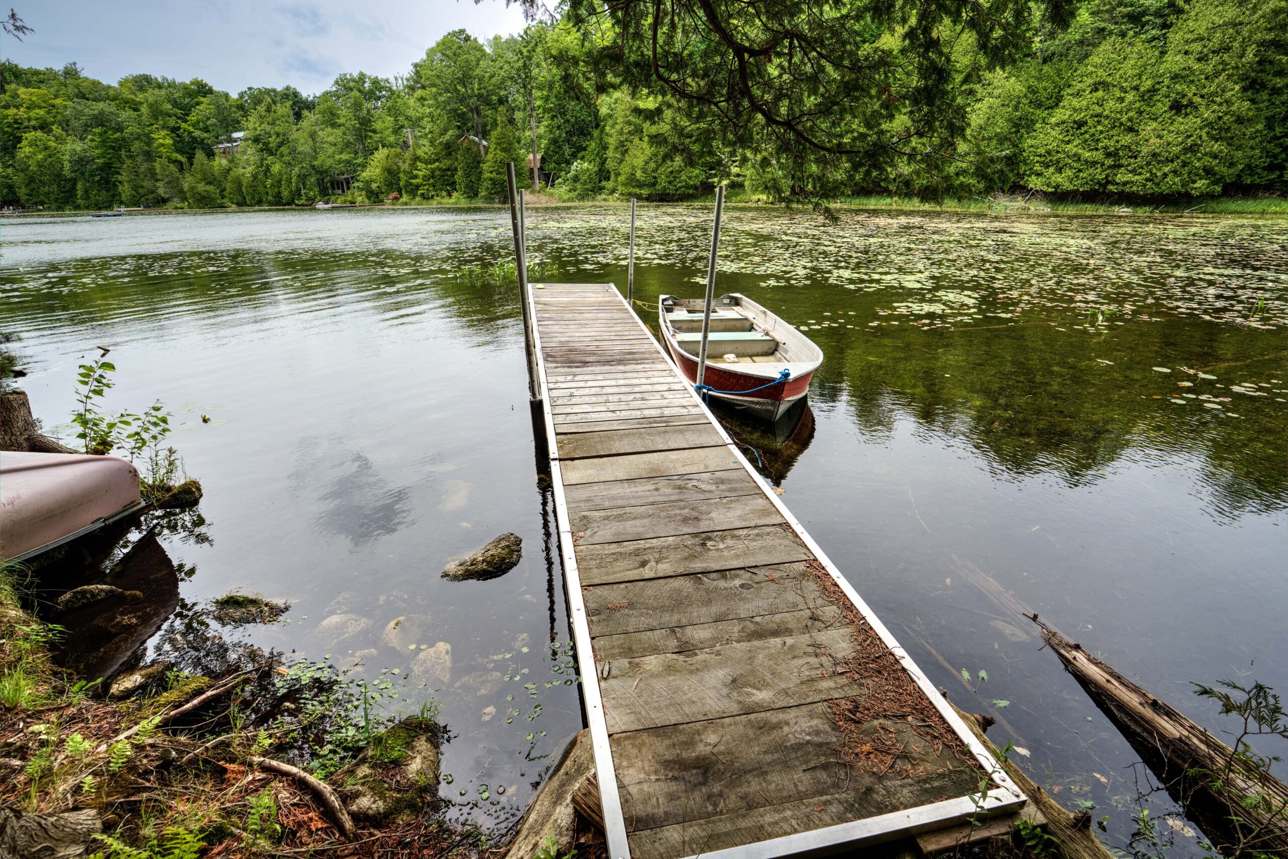A large wood dock on a lake