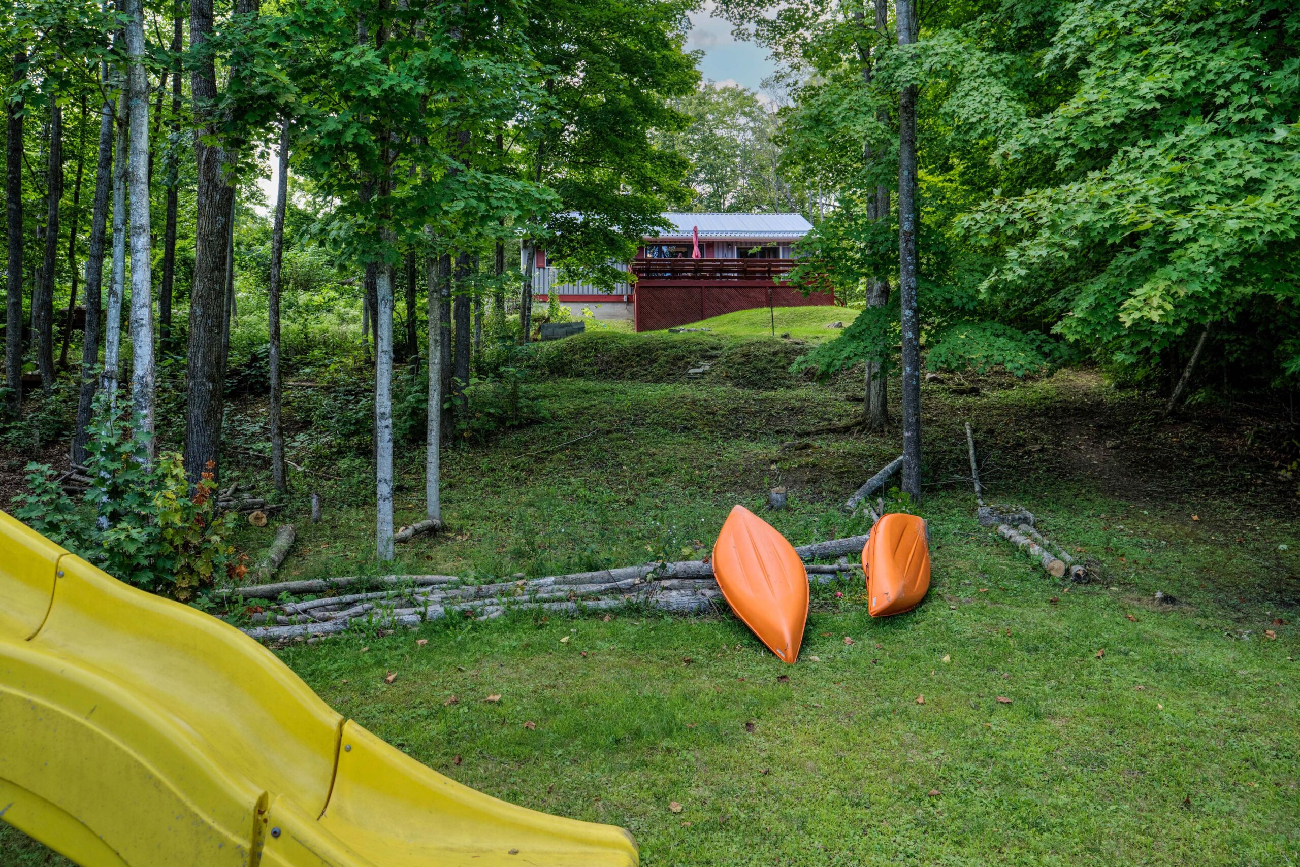 A large grassy area with a red shed in the distance