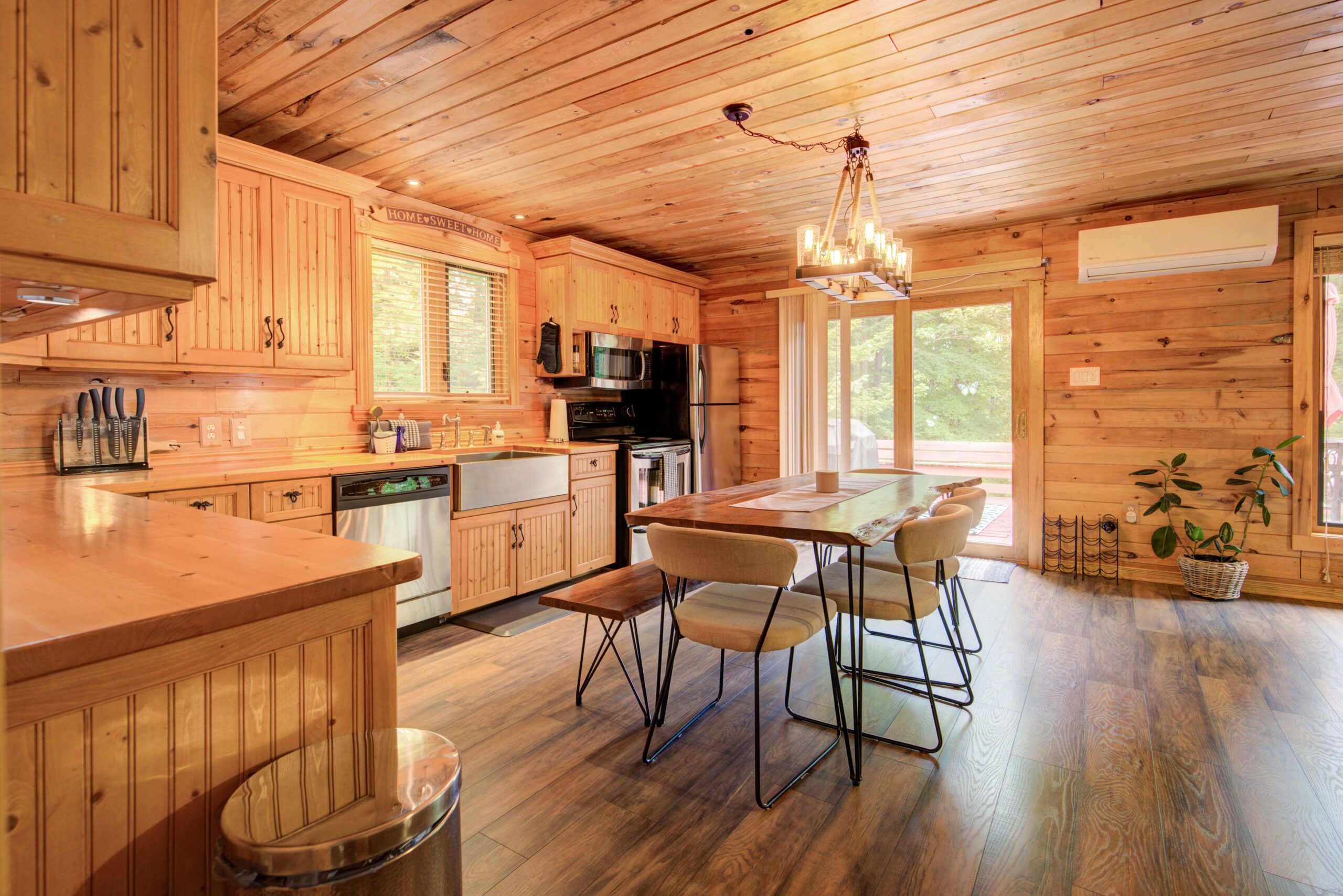 A wood dining table in a spacious wood-panelled kitchen