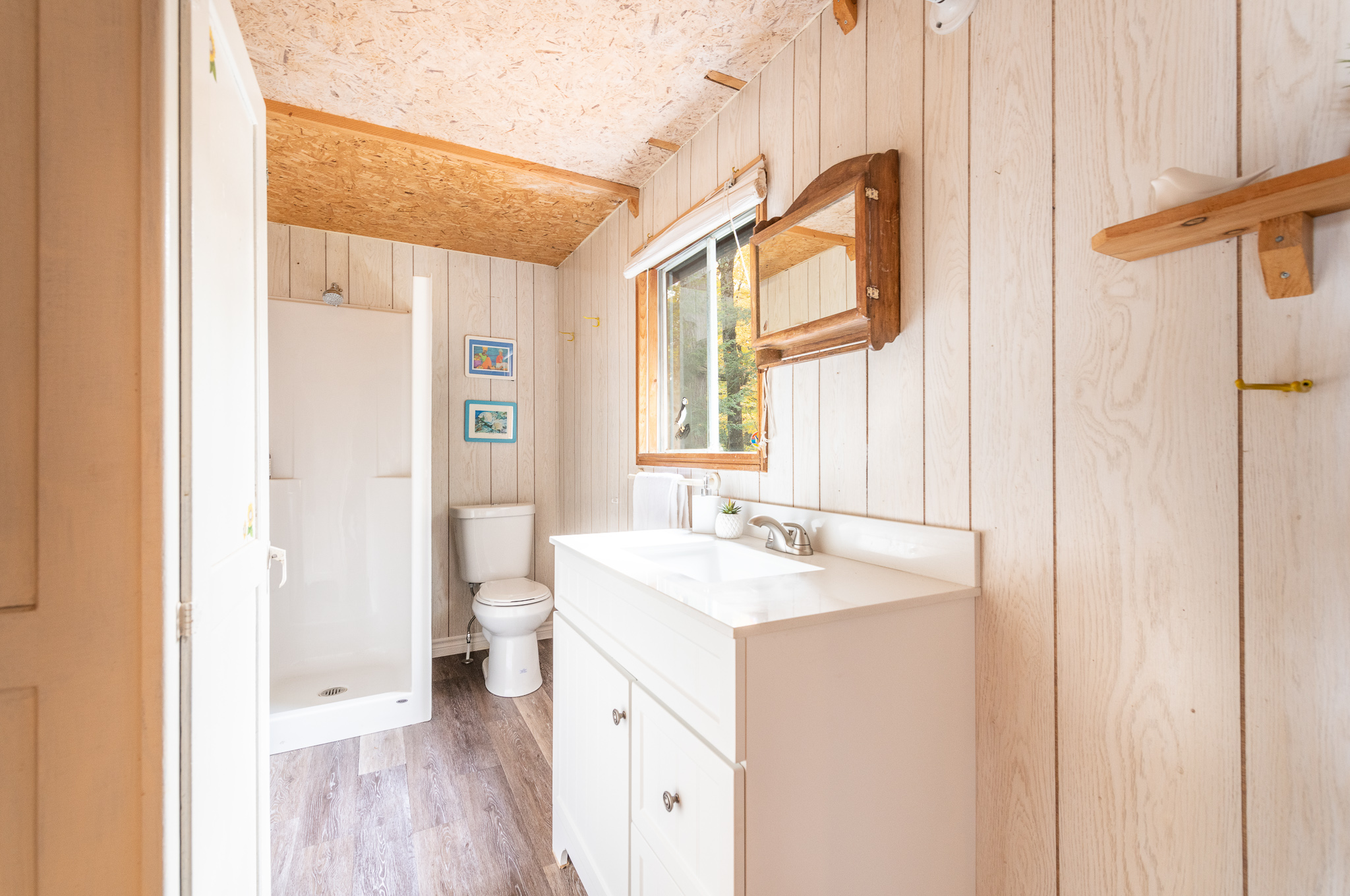 A white wood bathroom with a white vanity