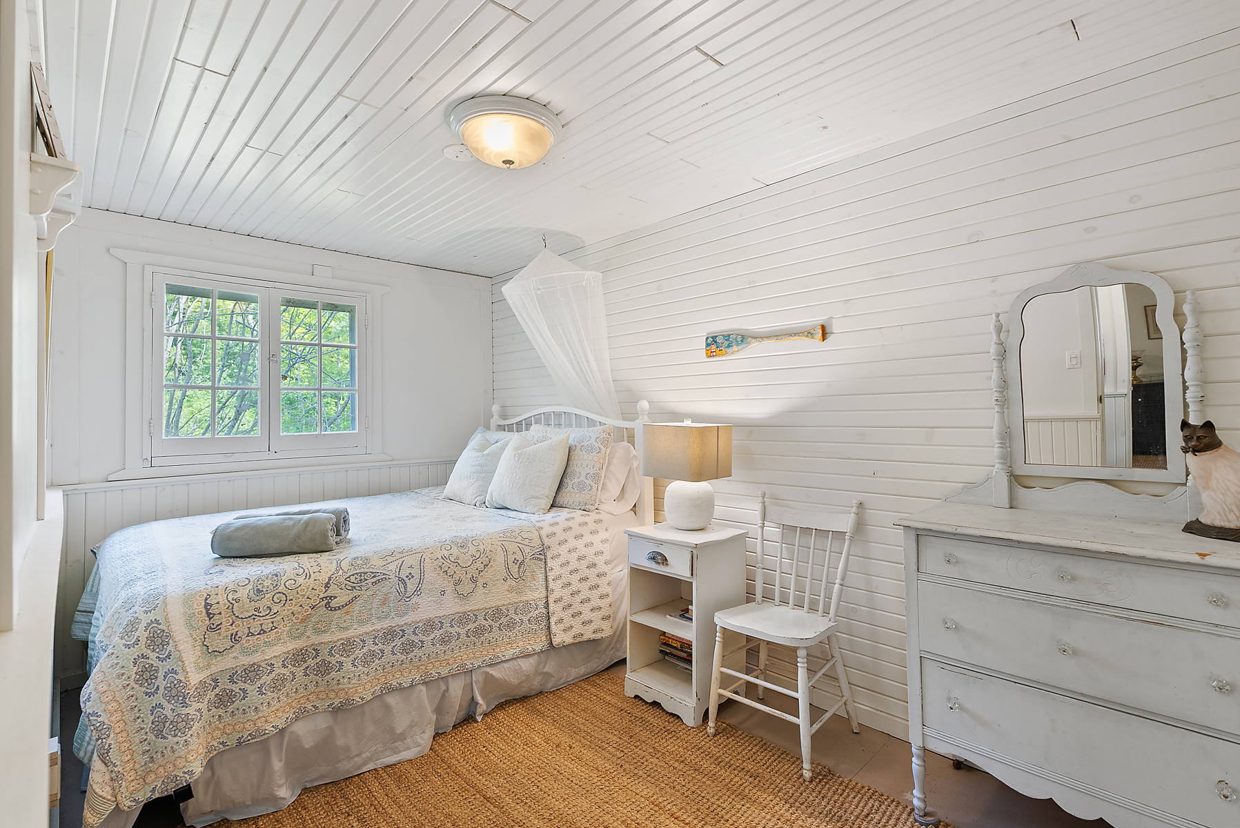 A white patterned bed in a white room