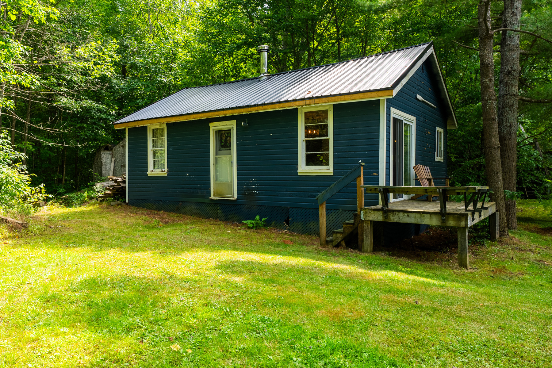A second, smaller blue cottage