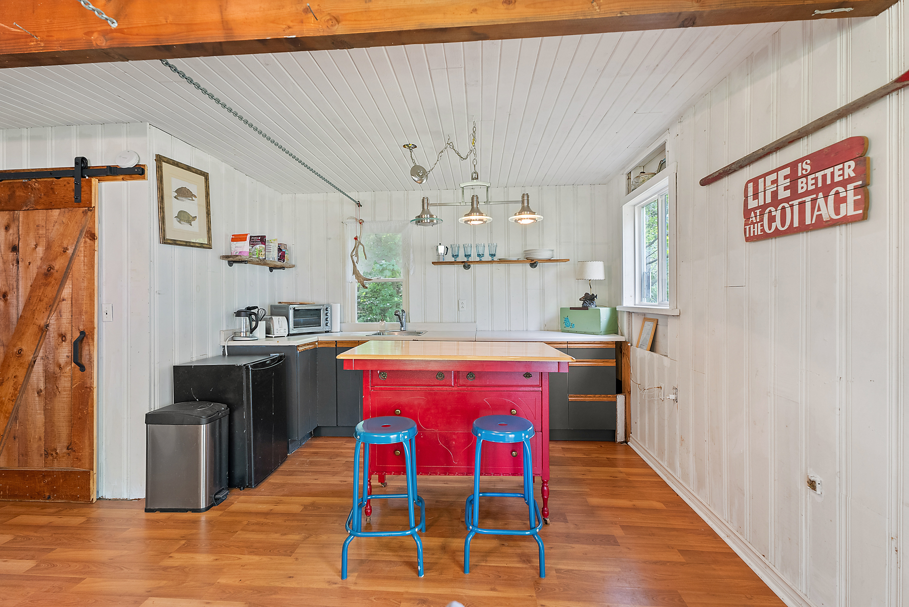 A red kitchen island in a white kitchen