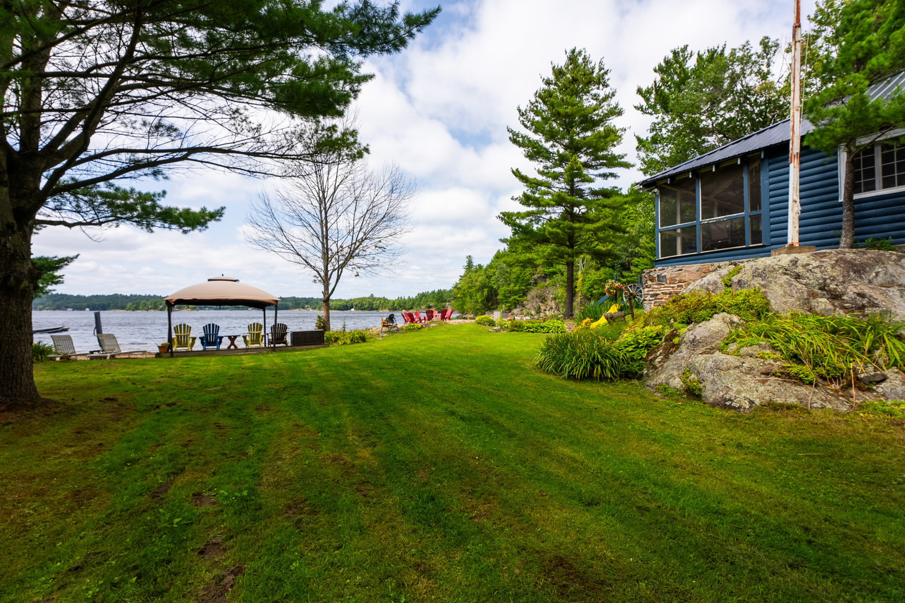a huge grassy lawn with a lake in teh distance
