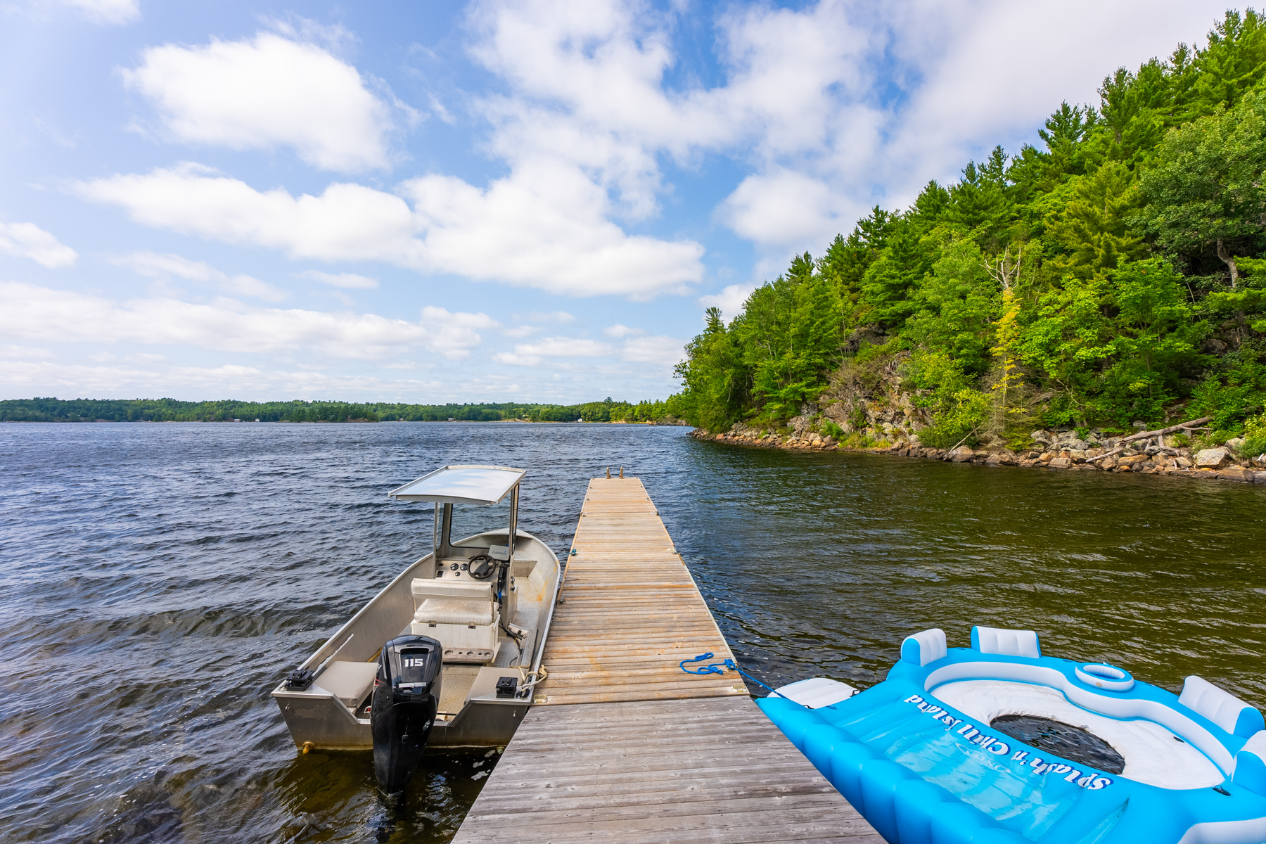 A long dock with a boat parked to the left