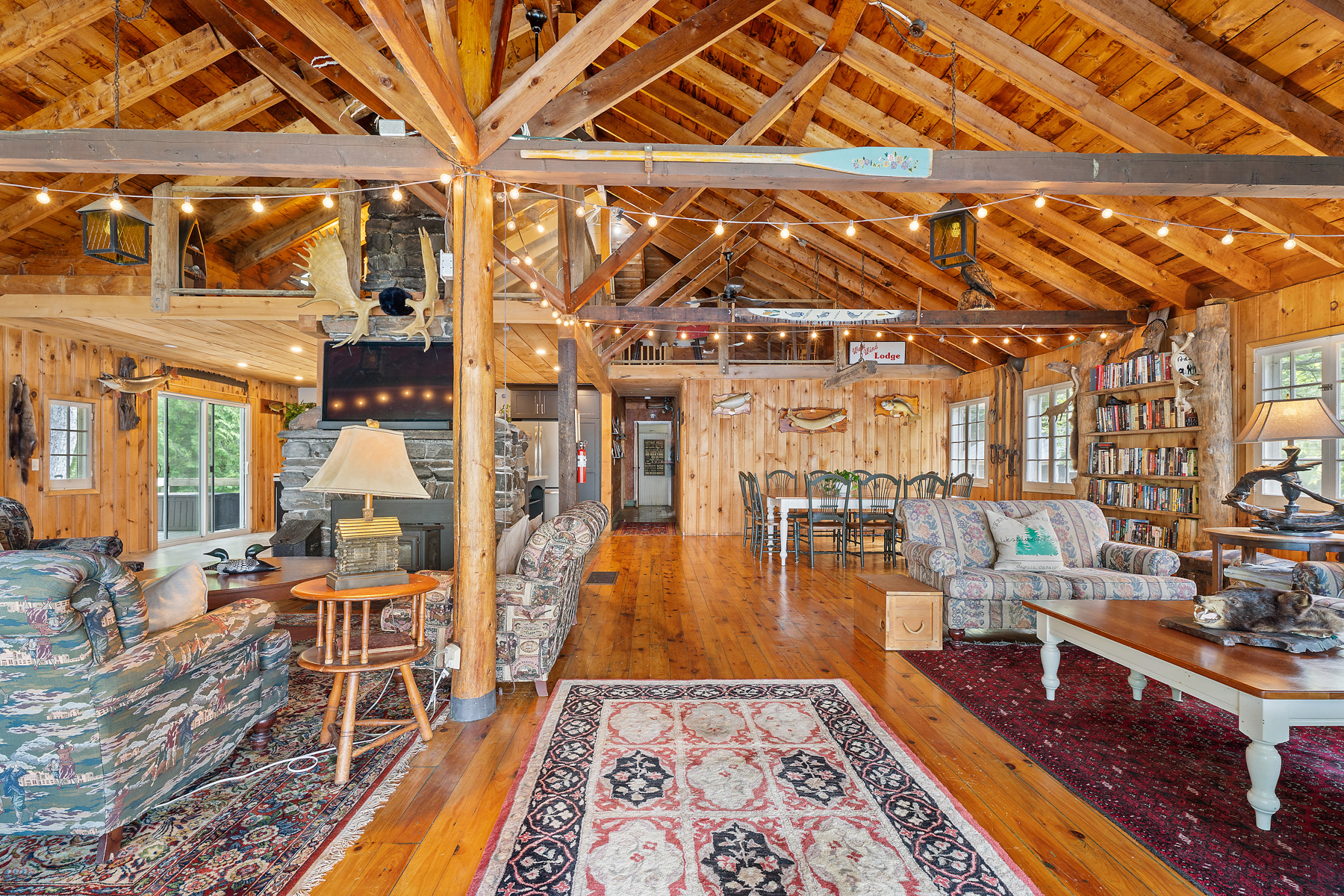A log cabin with vaulted ceilings and a large rug