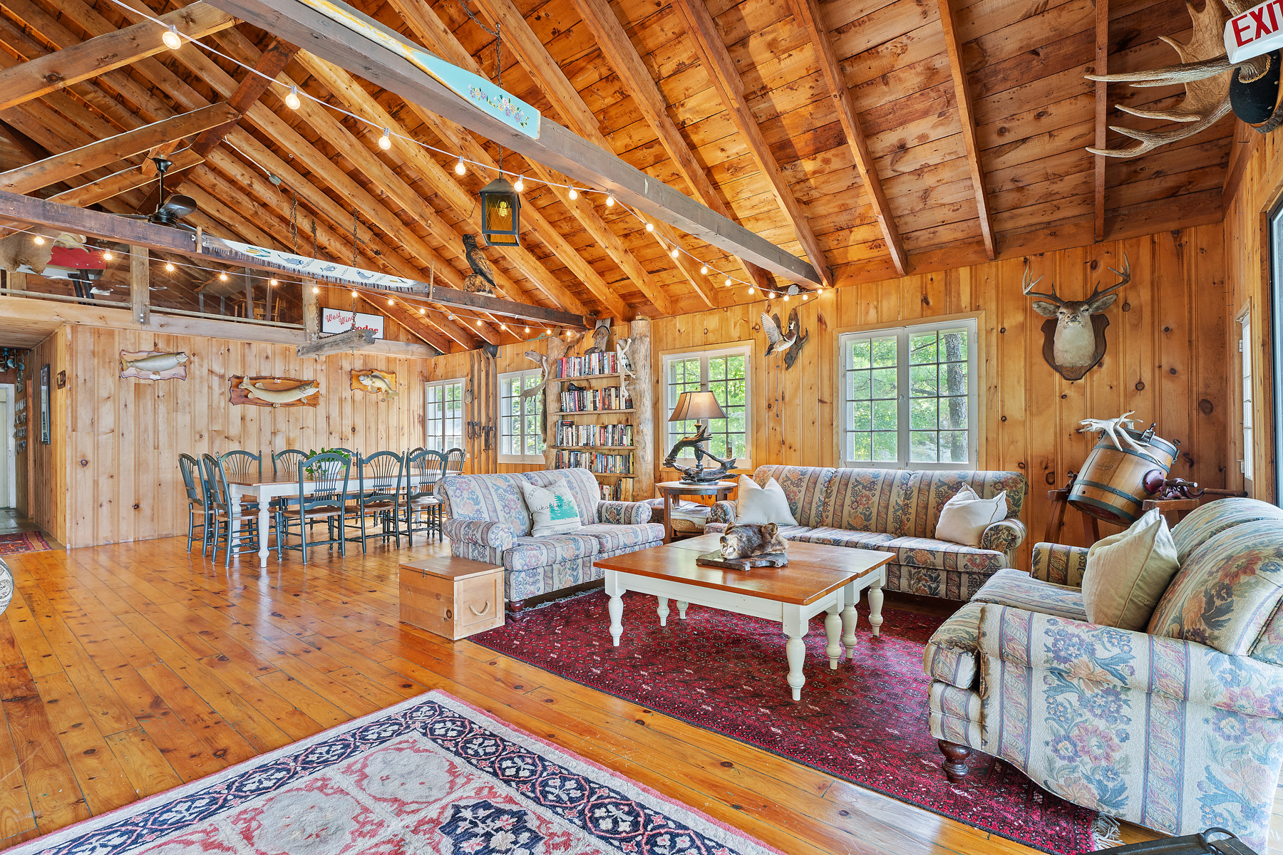A log cabin with vaulted ceilings and a living room space
