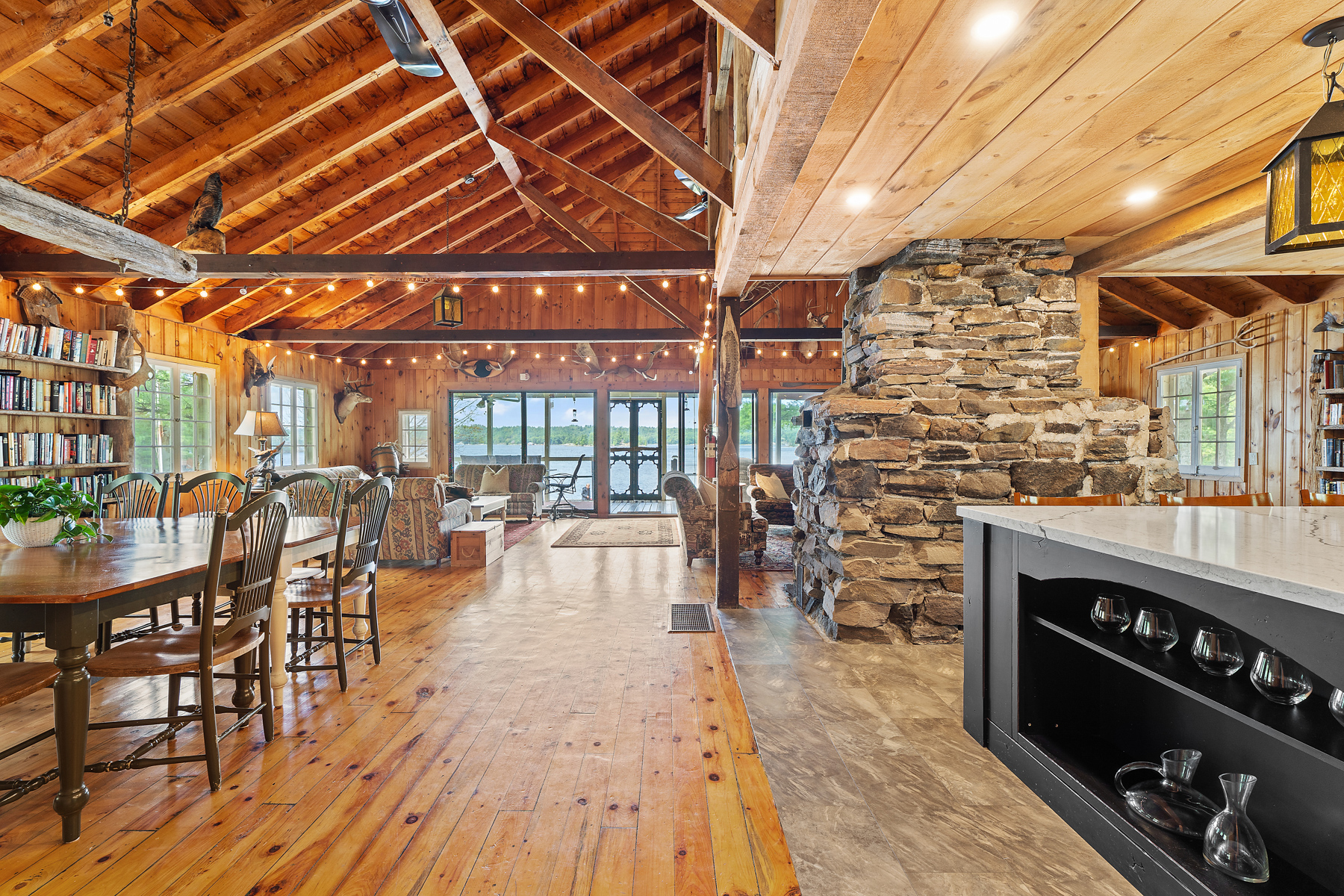 On the left, wood floors with a dining table. On the right, tiled floors