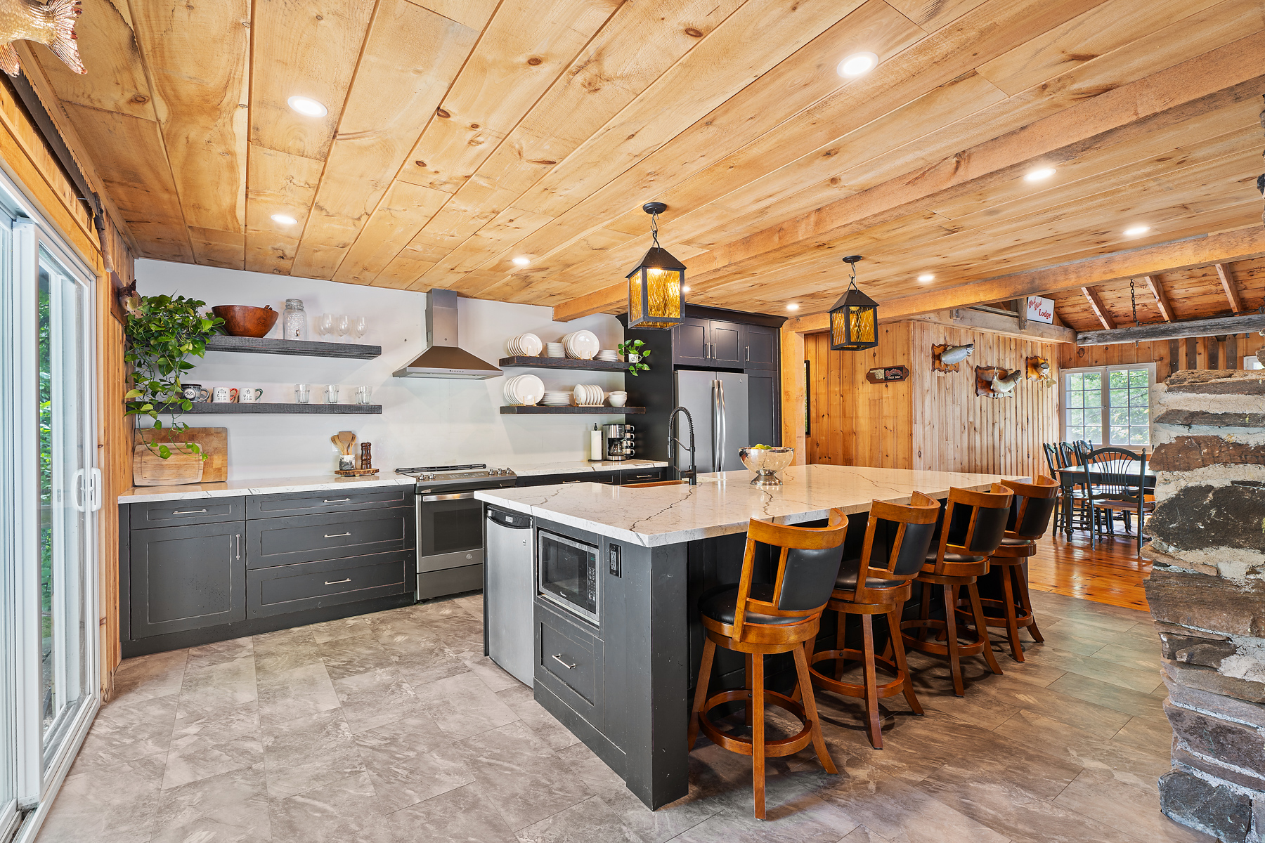 A kitchen with black cabinets and white countertops
