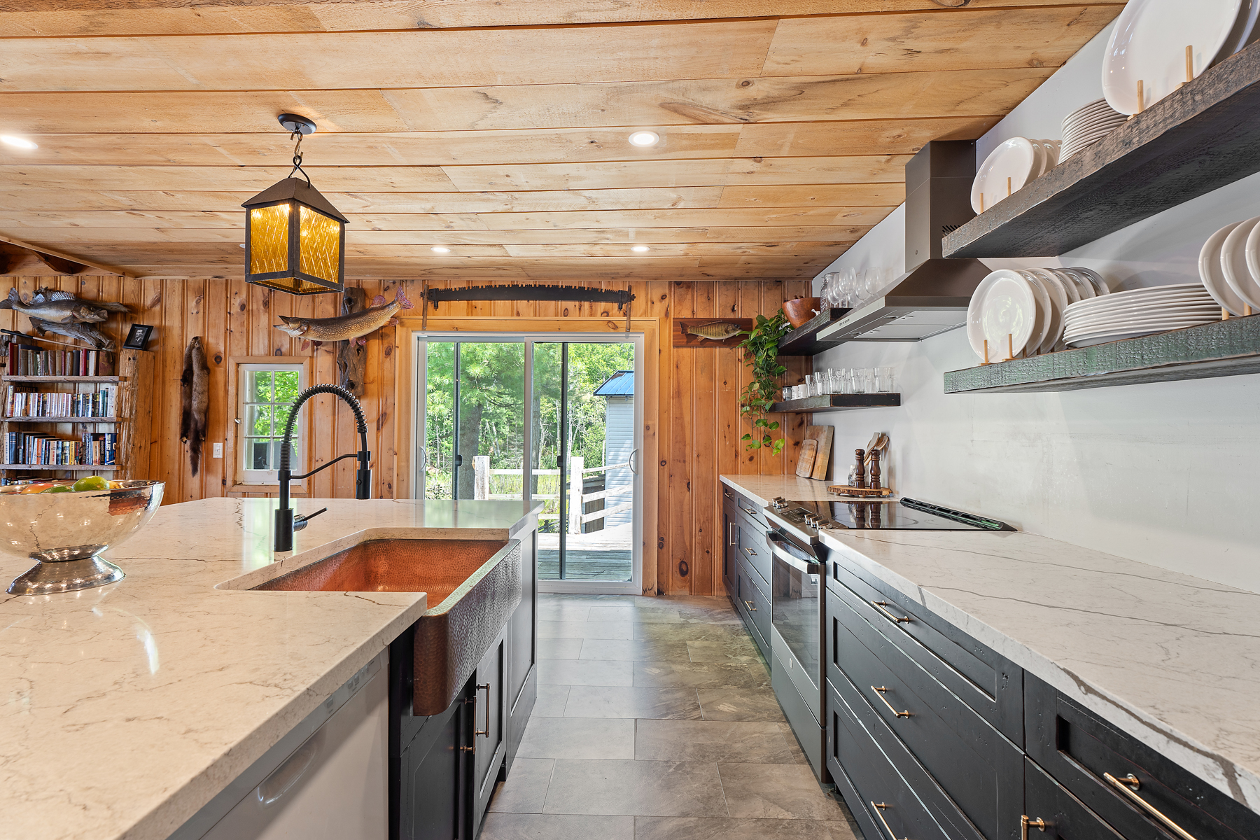 A modern kitchen with black cabinets and white countertops