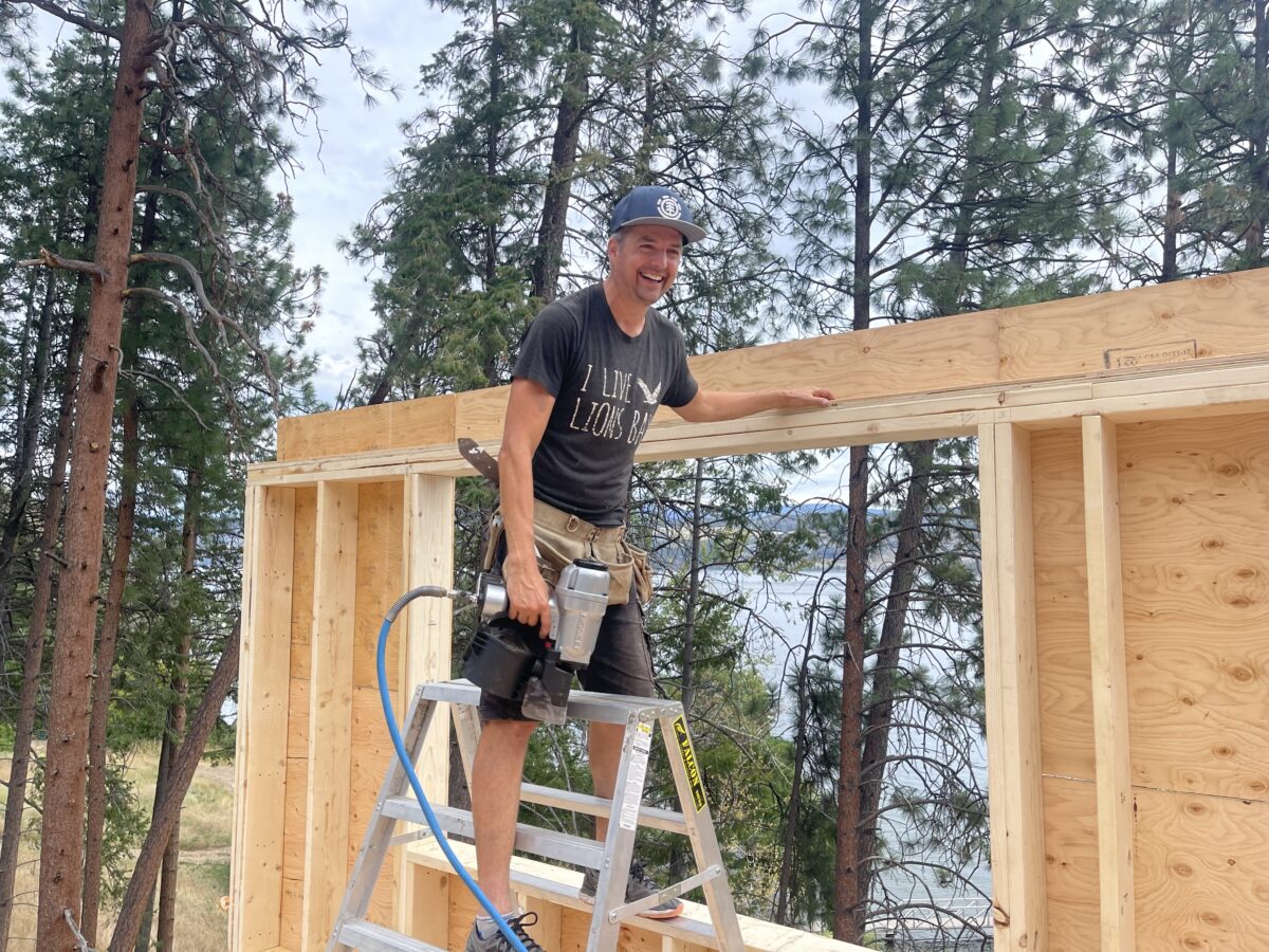 Contractor Todd Talbot stands beside a fence