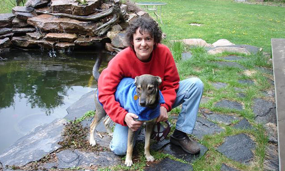a photo of a woman and a dog outside