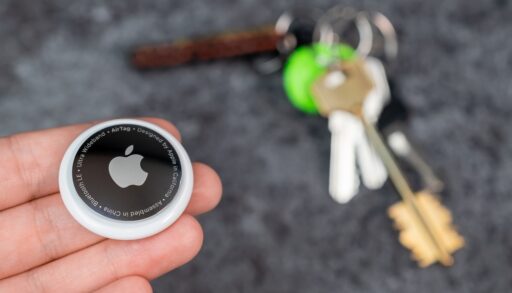 AirTag tracking device next to a set of keys