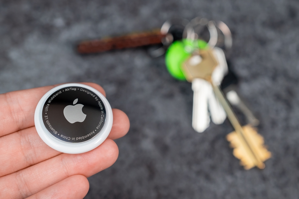 AirTag tracking device next to a set of keys