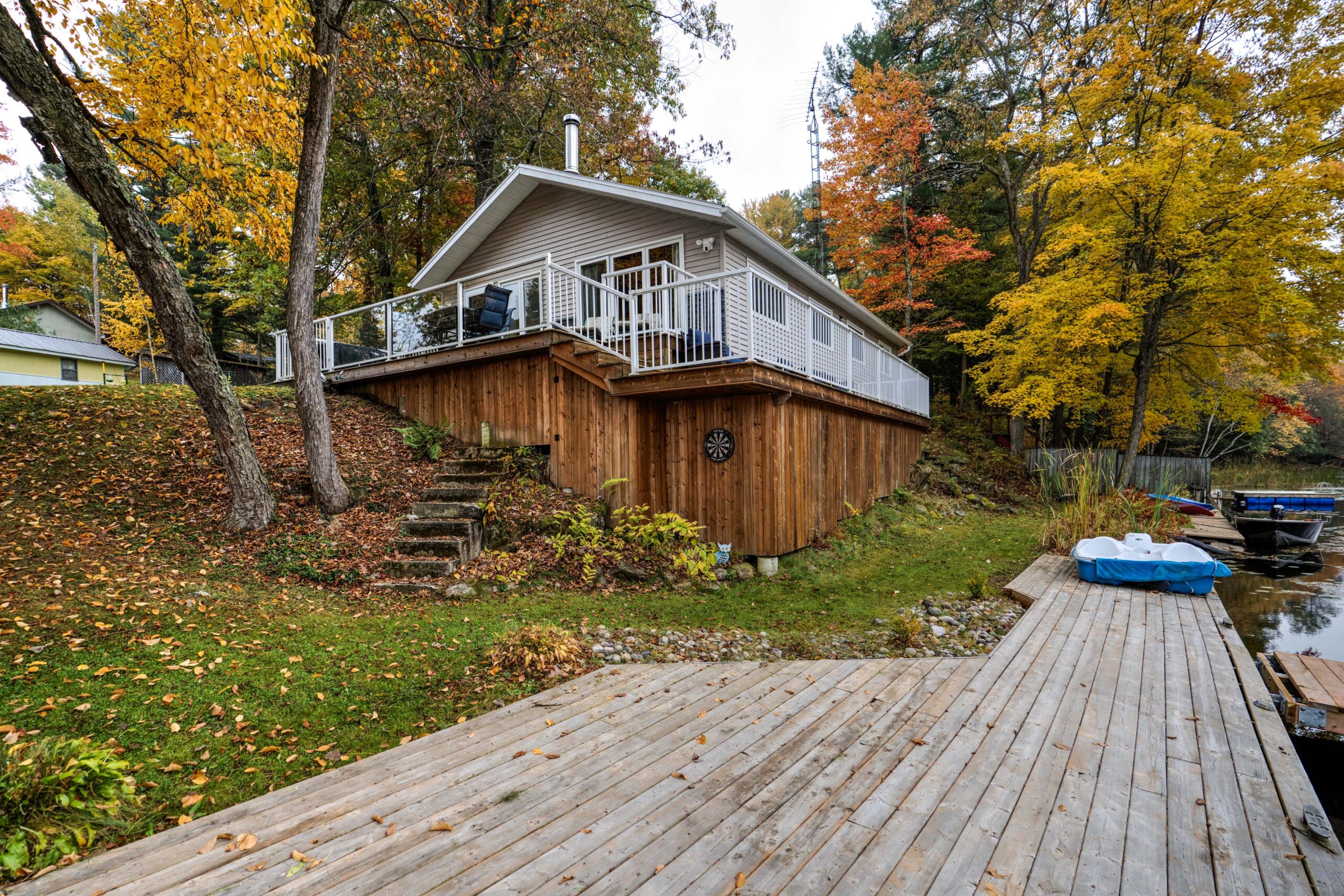 From the dock, a beige cottage with a wood foundation