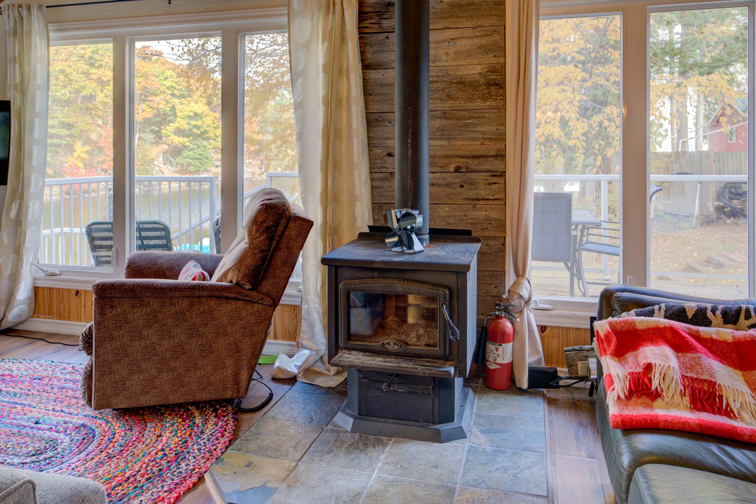 A wood stove next to bright windows