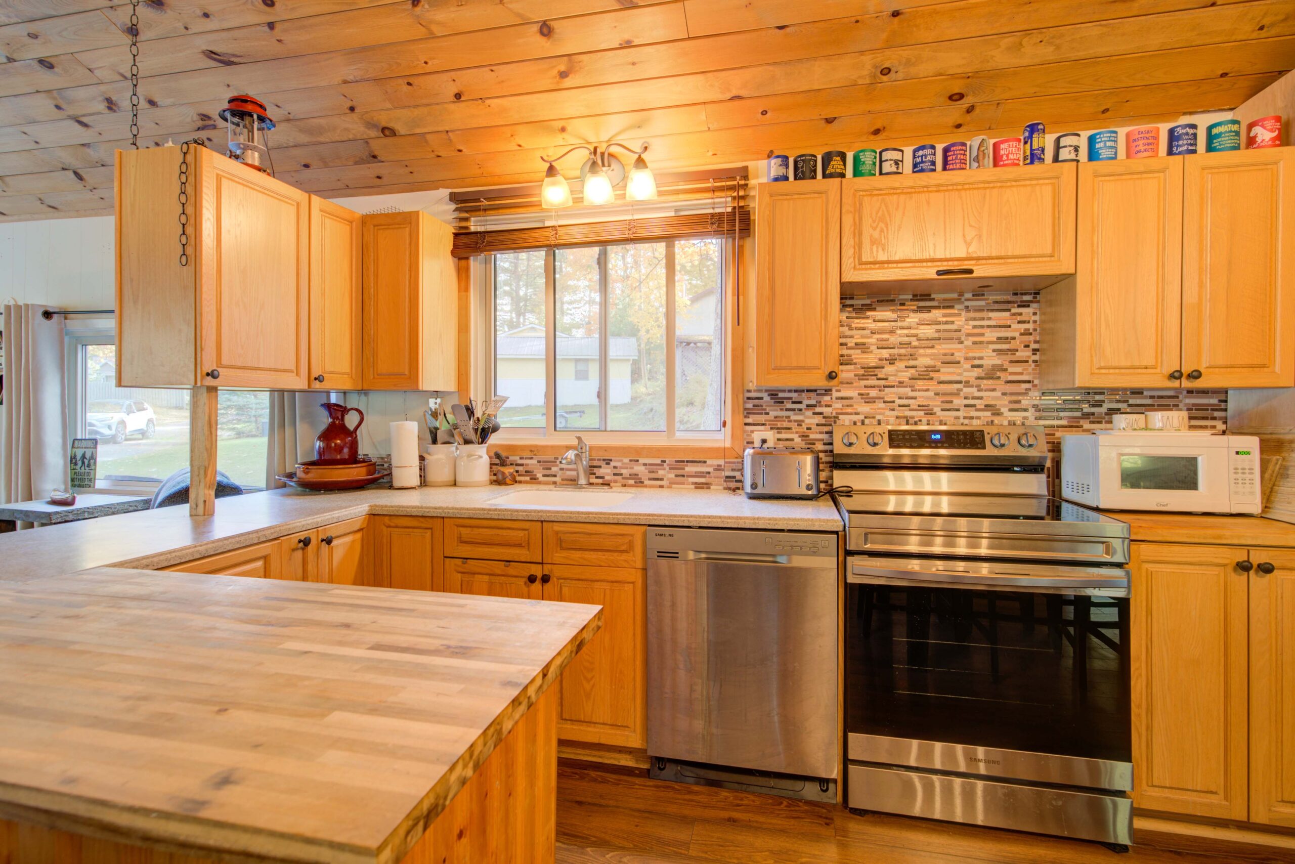 A brown wood kitchen with stainless steel appliances