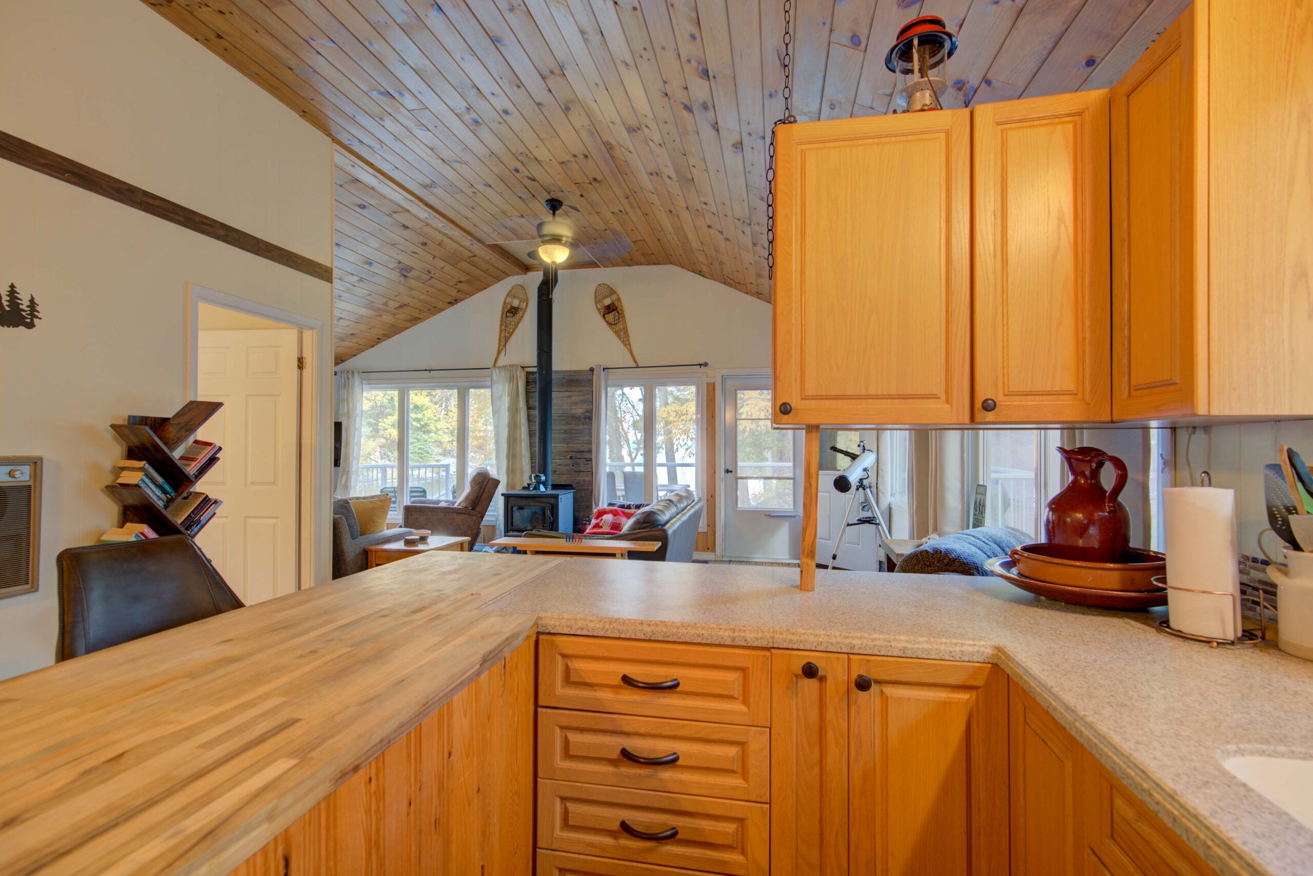 A brown wood kitchen with white countertops