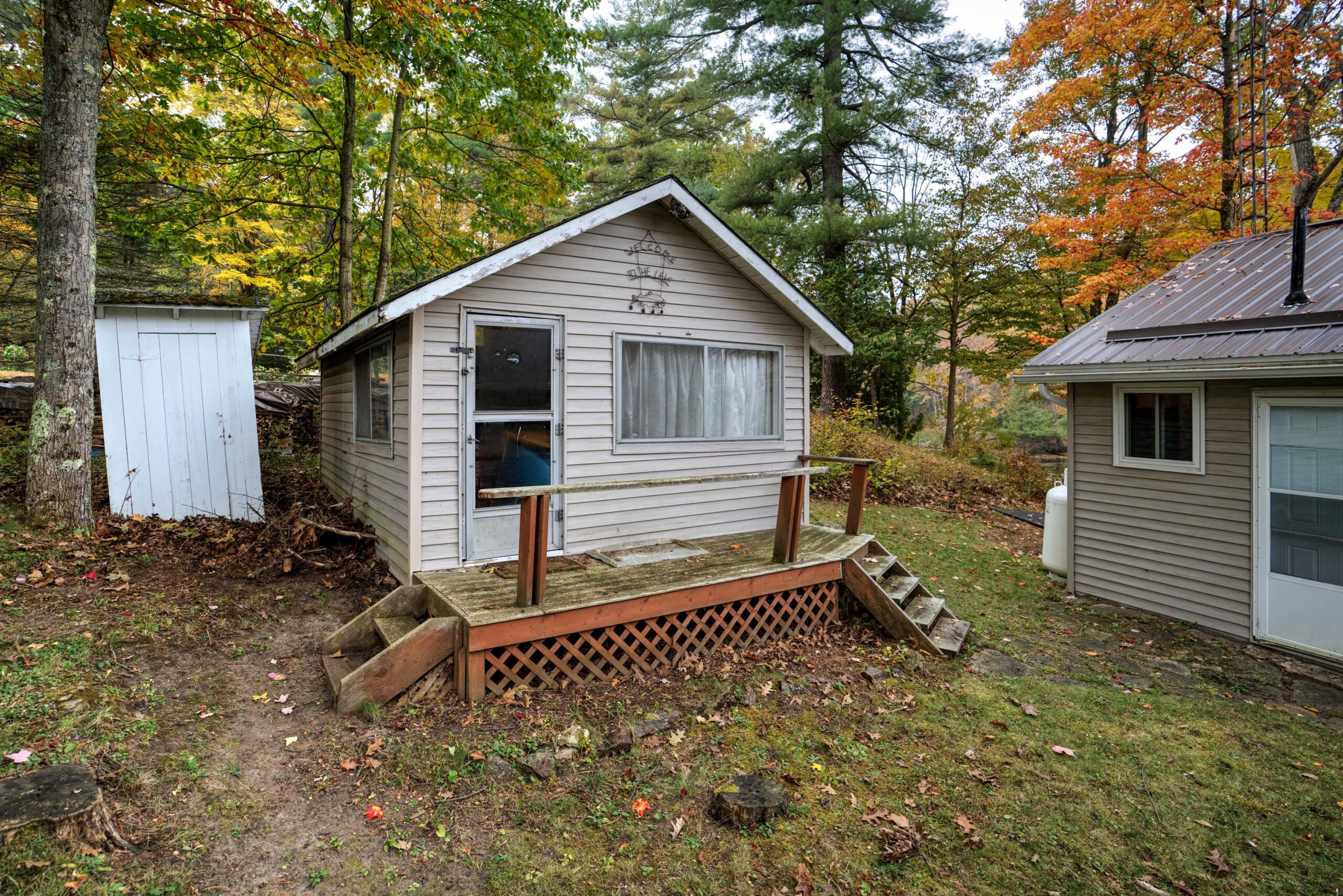 A small beige cabin with brown steps