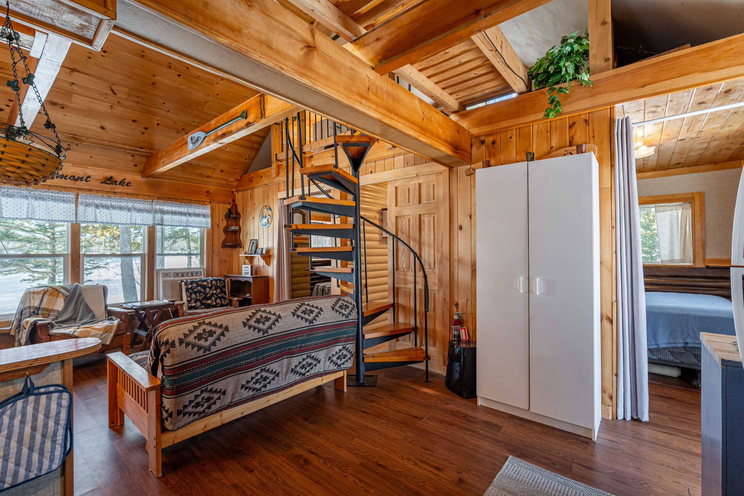 A patterned couch in a log cabin