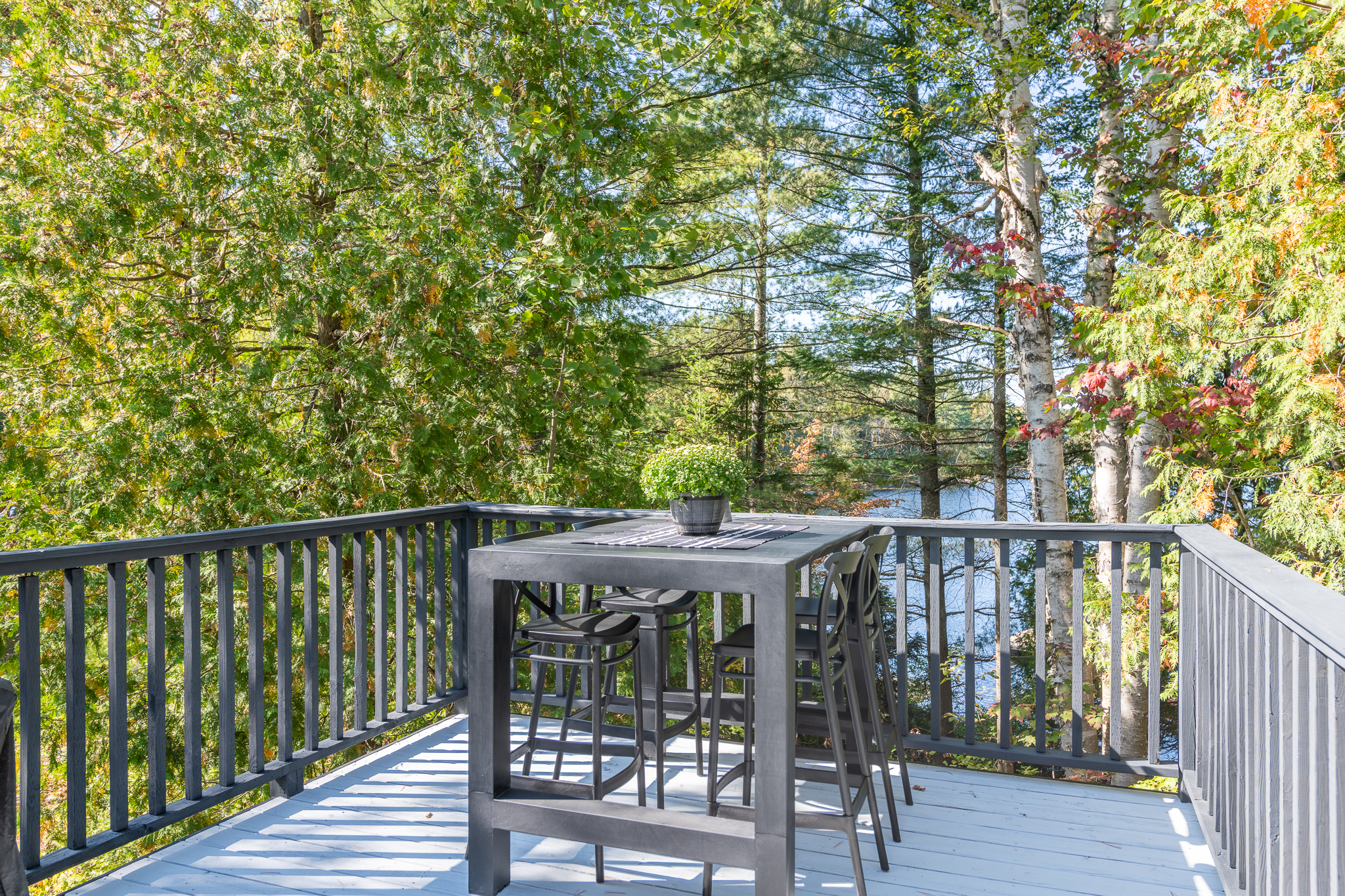 A high-top dining table on a deck
