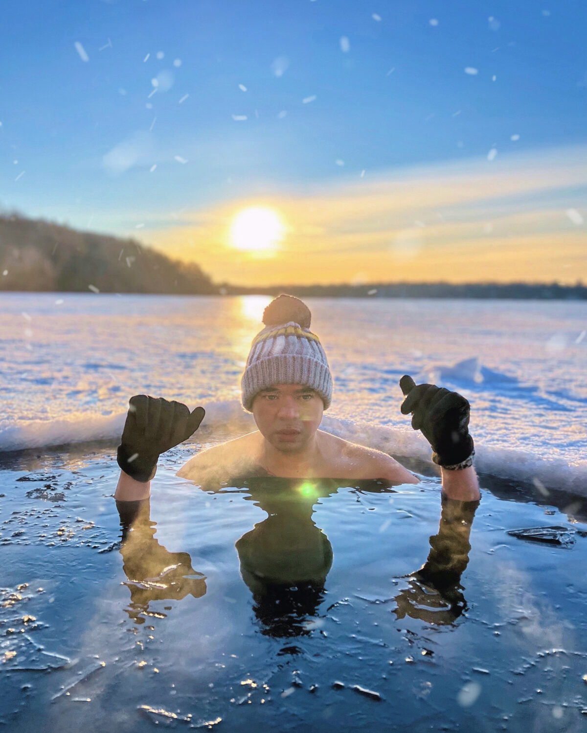 A man partially submerged in an icy lake