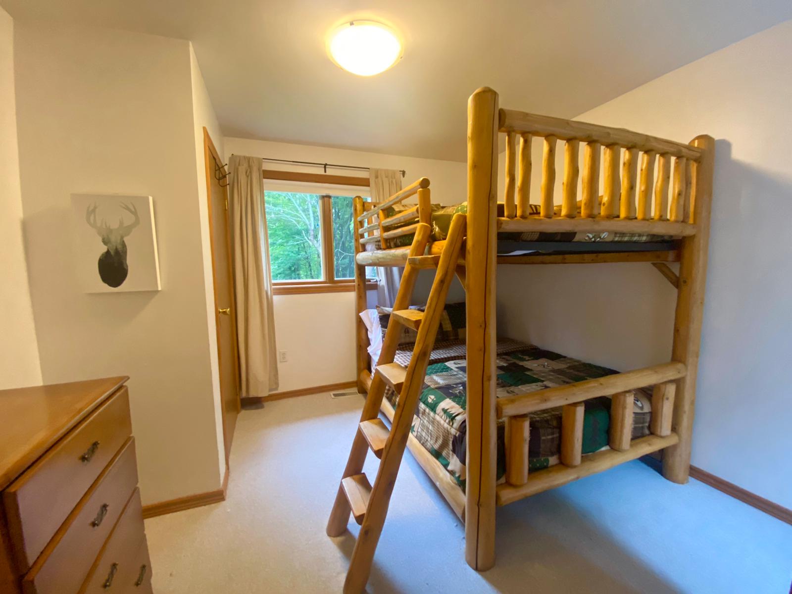 a bedroom with wooden bunkbeds