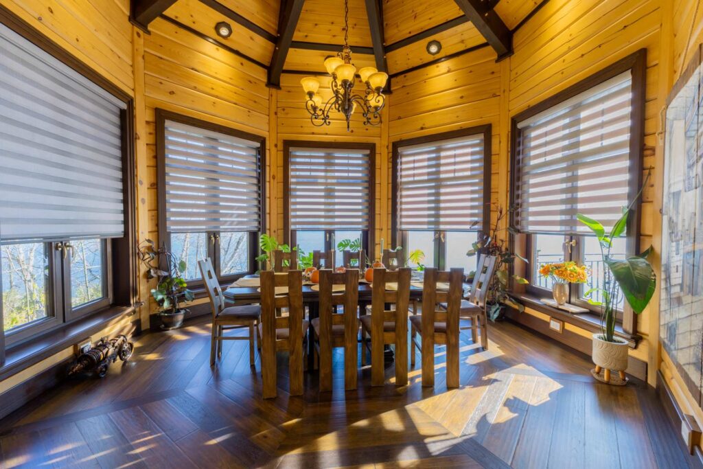 A round wood table with wood chairs in a rounded room with a dome ceiling