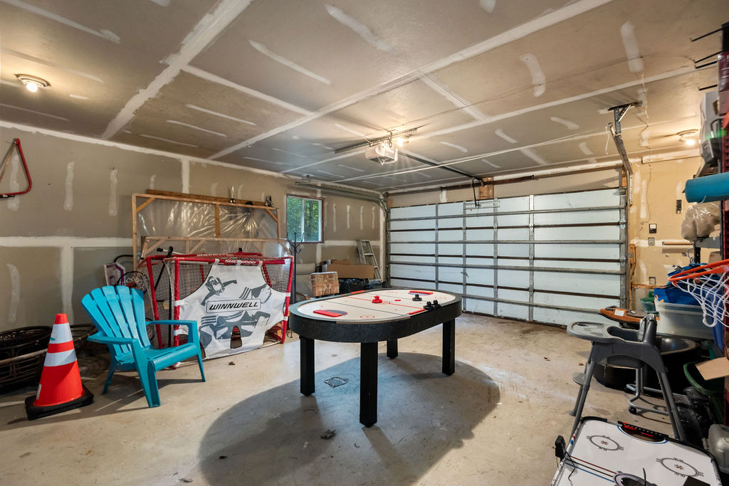 The inside of a garage with an air hockey table and storage
