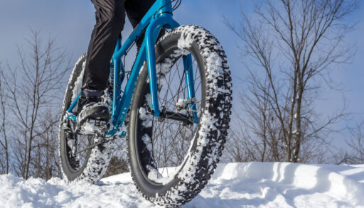 A from below shot of someone on a fat bike on a winter trail