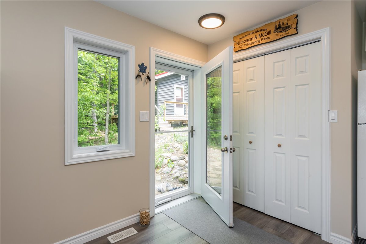An open glass doorway in a beige-painted foyer