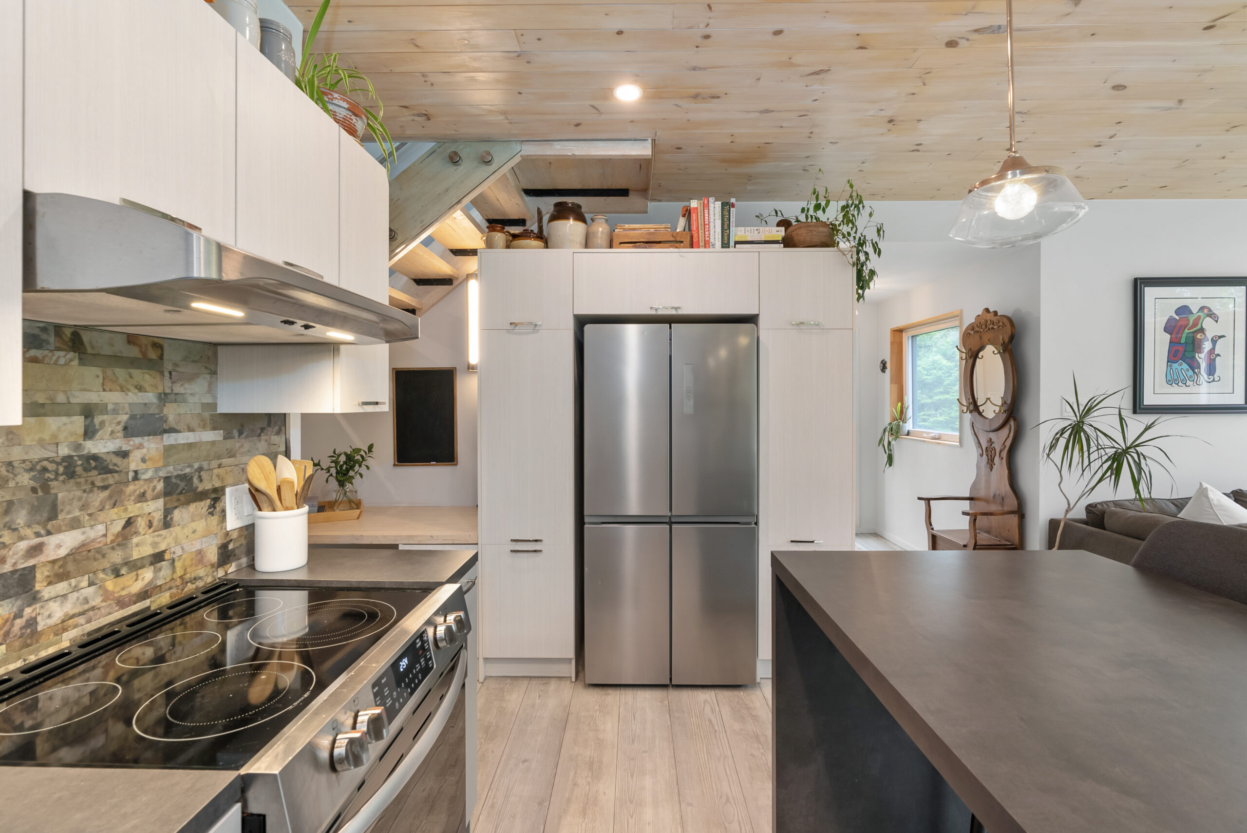 A stainless steel fridge is built into a white wall