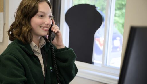 young person in an Ontairo parks sweater answering the phone