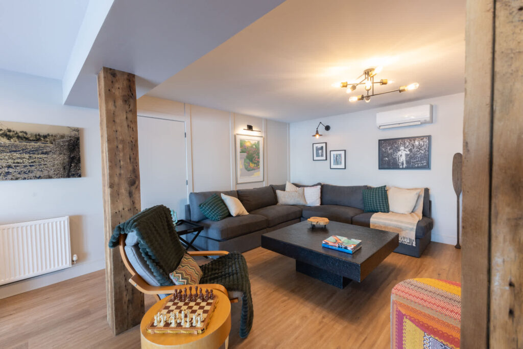 A grey sectional in a white basement
