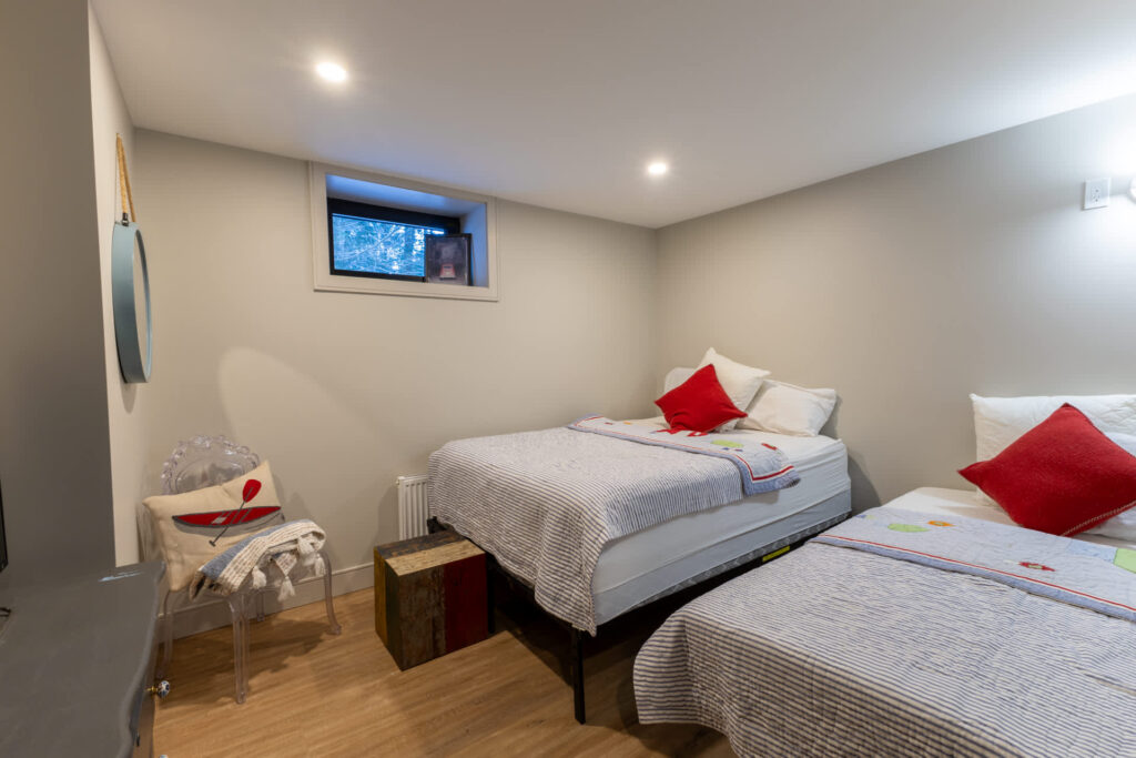 Two beds in a small basement room