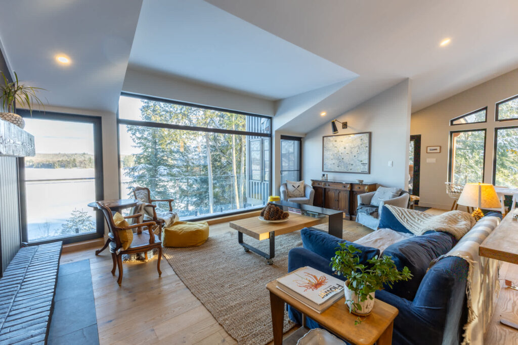 A blue couch faces a huge glass window