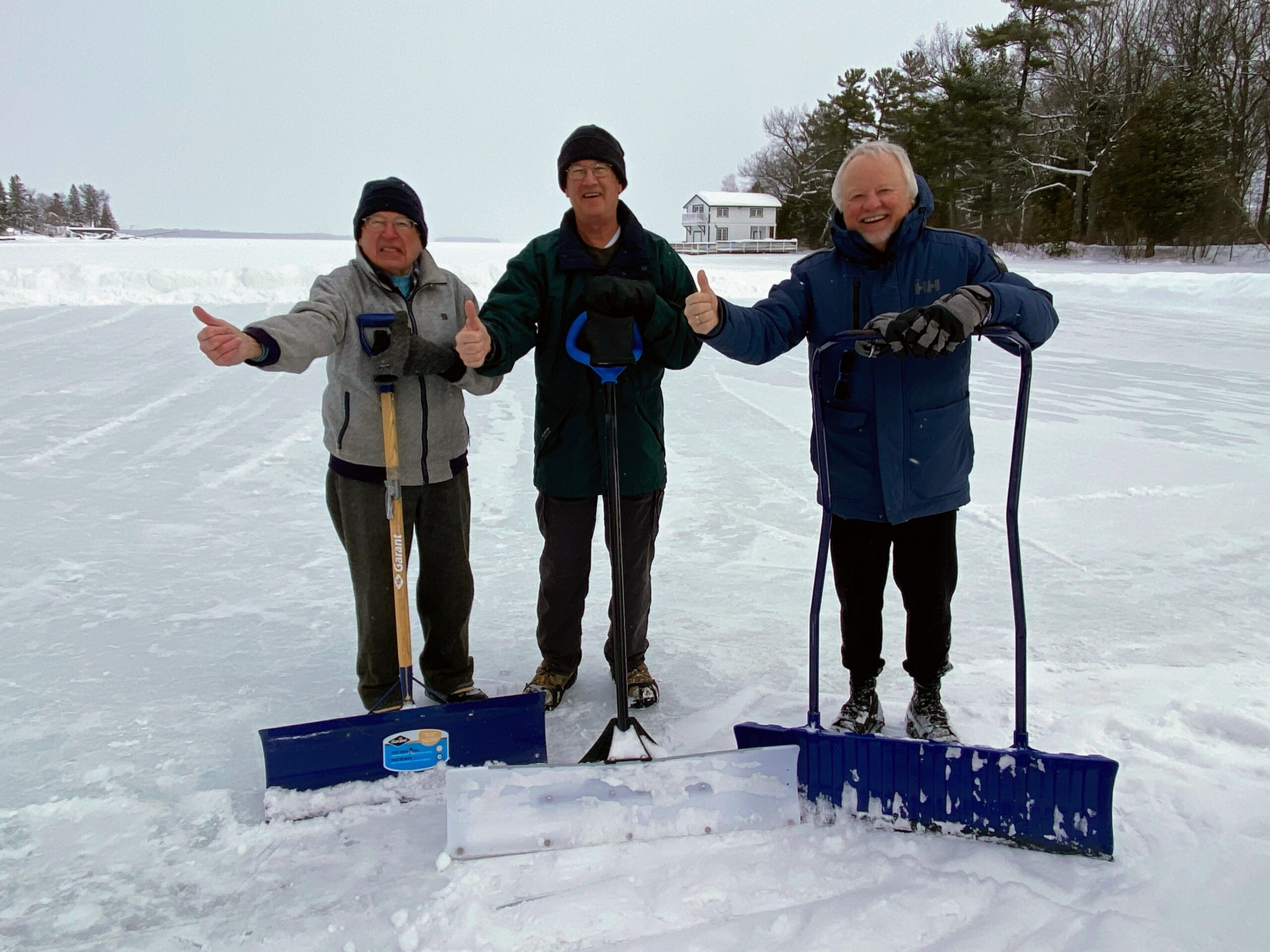 The rink-makers standing on the ice with their shovels