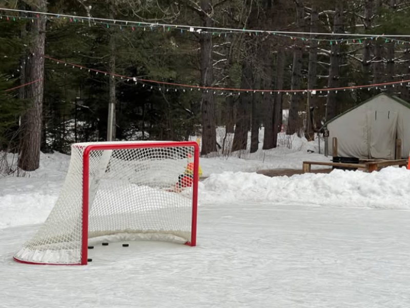 A hockey net set up on an outdoor ice rink