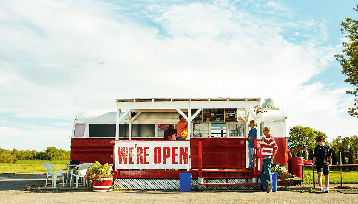 a photo of a chip truck against a blue sky with white clouds