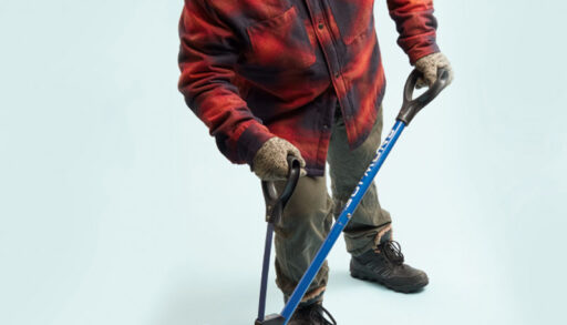 a photo of a person in a plaid jacket holding a shovel