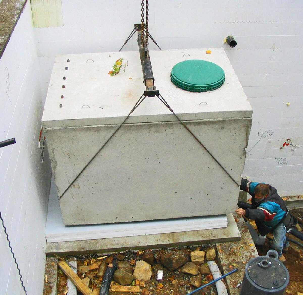A large water tank held by a hoisting lift