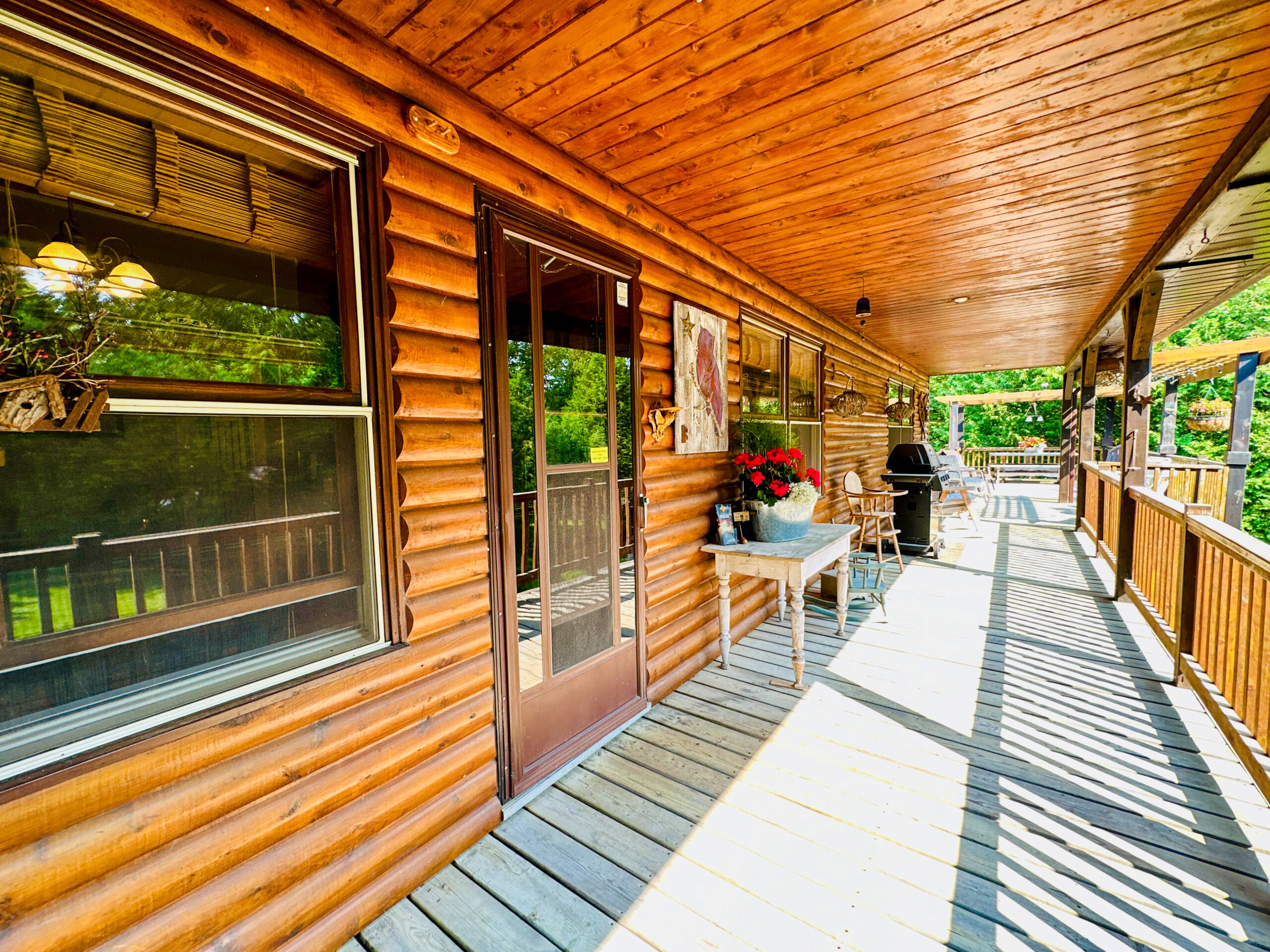 The welcoming entrance to the main house, featuring a covered porch and rustic wood detailing.