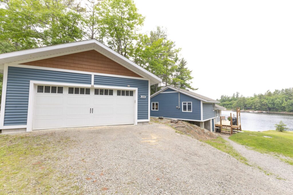 A blue paneled garage with a white door