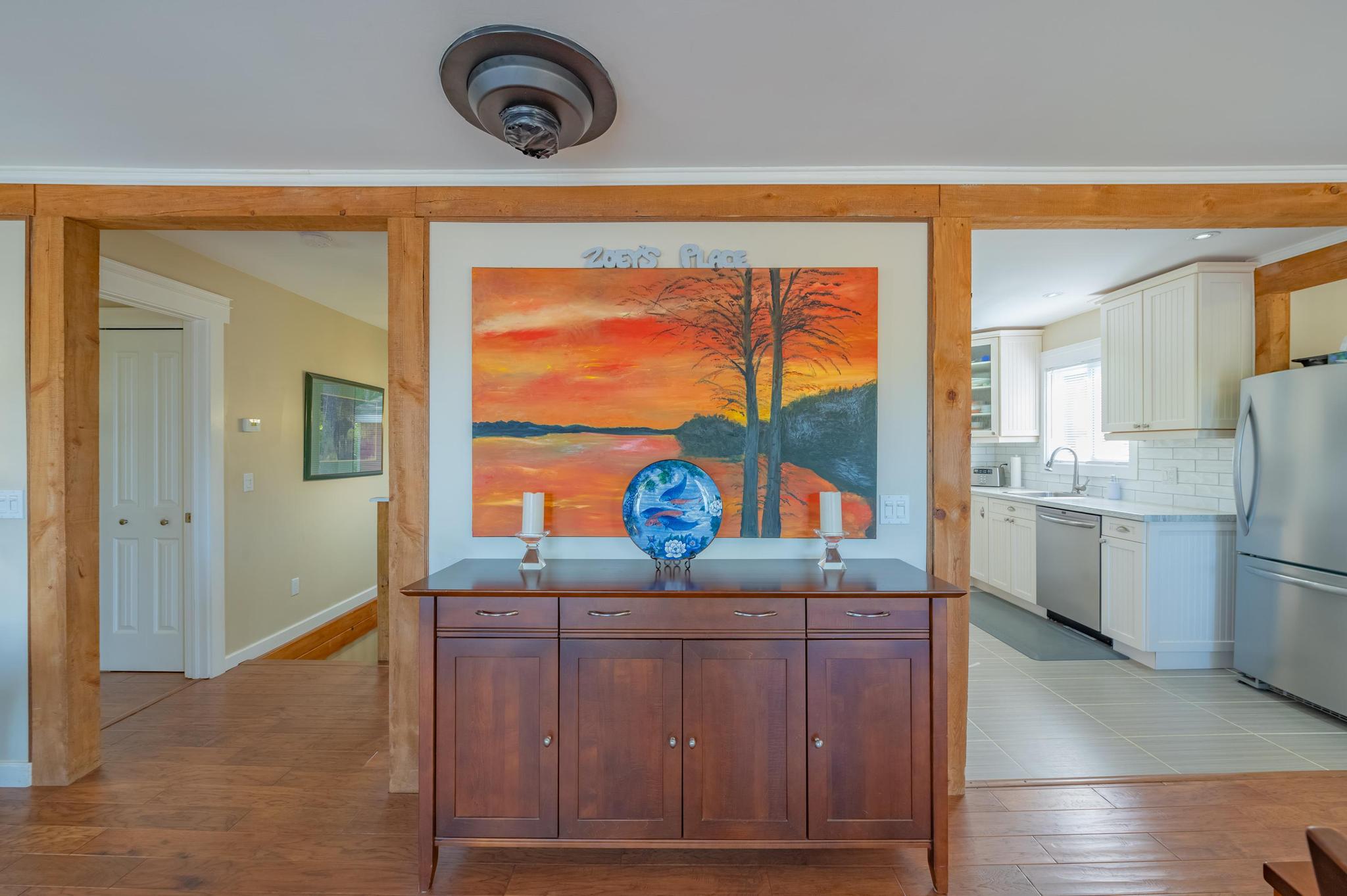 A well-lit hallway featuring modern artwork and stylish decor.