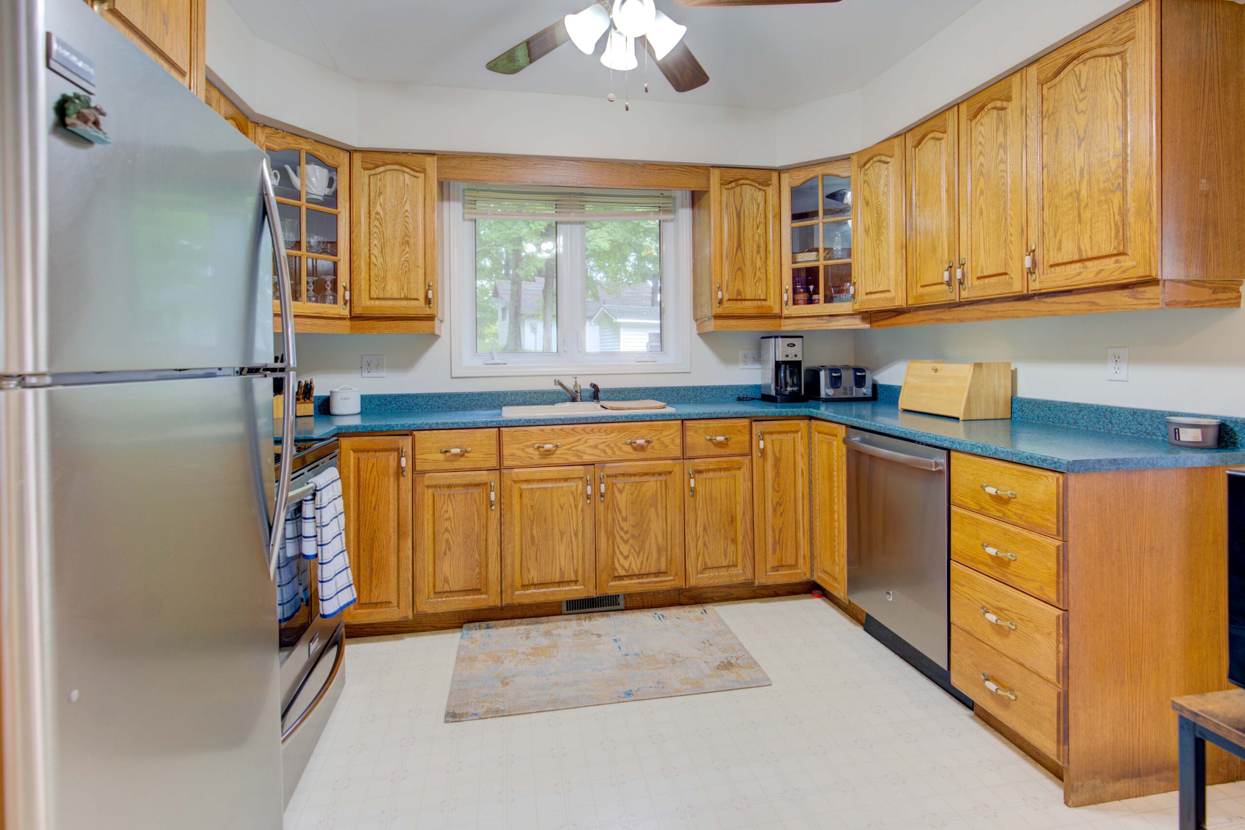 A small kitchen with wood cabinets and a